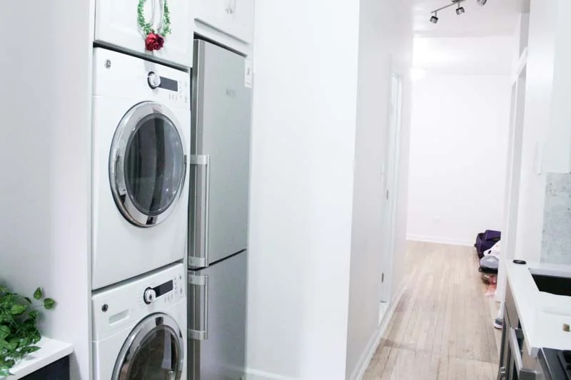 When you first walk in there is a mini-kitchen area, with a washer and dryer, stove and oven, dishwasher, and microwave. Down the hall is the bathroom and some closet space. 