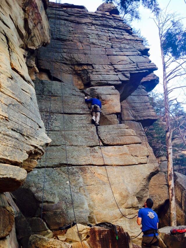 Plugging gear on the warmup route at the local crag.