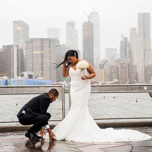 Love this candid photograph of the groom fixing his wife&rsquo;s wedding dress for the perfect portrait on a rainy day🌧 ☔️ .
.
.
.
.
.
#jeanpierrestudio #coupleinlove #weddingphotojournalism #lovelycouple #newyorkphotographer #thecoordinatedbride #s