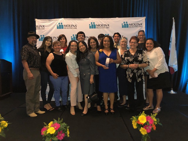 Tomasa celebrating with family, friends, and Bayside Community Center staff.