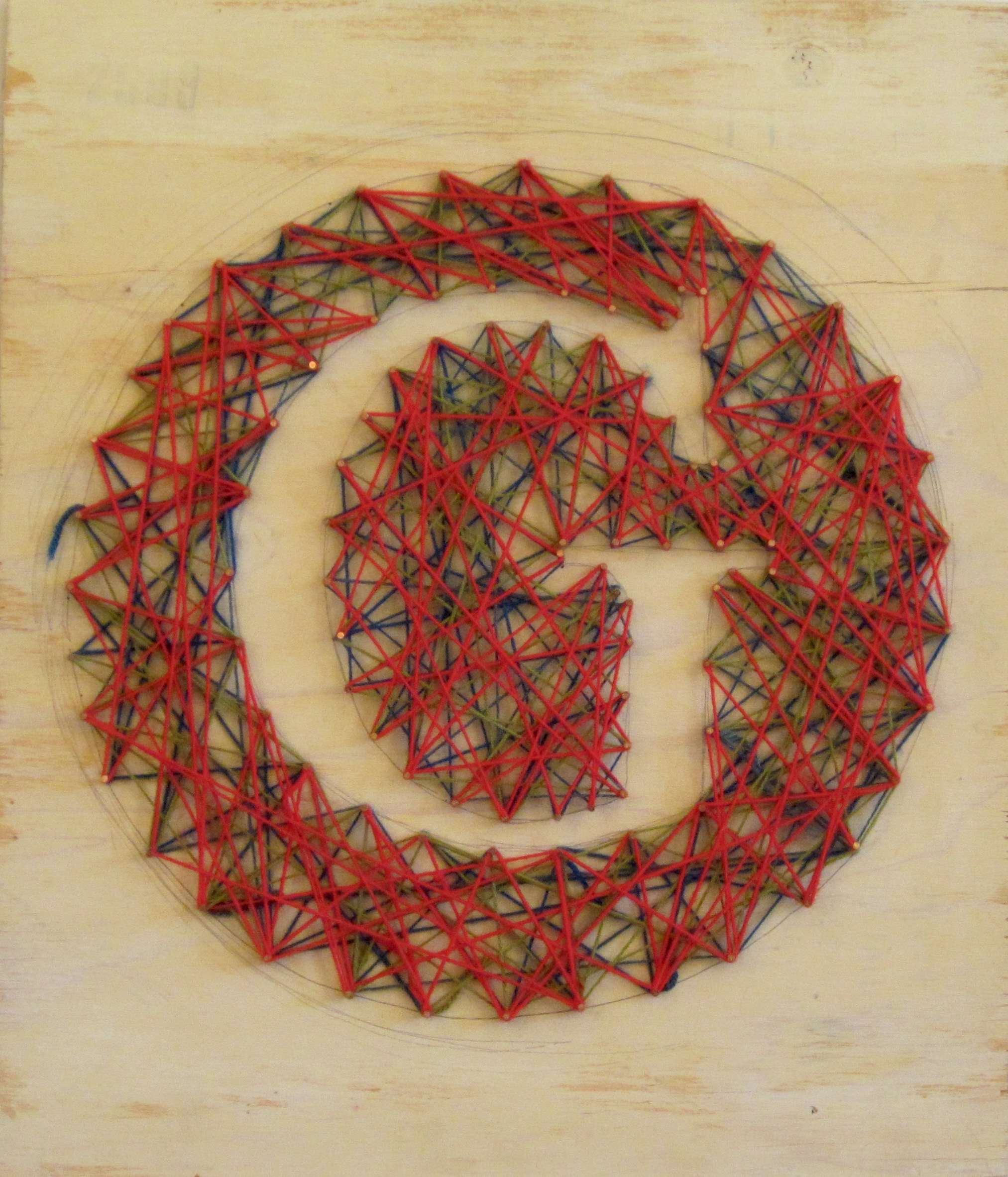 “Niagara Fails With String Theory Fall Back” (Back) Ralph Waldo Gerickson, 1968 Tinted oatmeal on plywood, acrylic knitting yarn, nails Here Gerickson, has turned the piece over and used the flip side of his failed waterfall (see previous image) to create one of the first models for the burgeoning new theoretical framework called bosonic string theory. Unfortunately, his fellow physicists Hawking, Feynman, et al, rejected his ideas while making it clear that blue string is the only possible color to be used in any future models of one-dimensional objects and that the Letter “G” shape appeared somewhat biased. Unfazed, Gerickson continued his work and has since made significant inroads with his research in the field of cessation of the cessation of the 5 senses while breaking on through to the other side and simultaneously searching for terminal gamma-ray flashes that are emitted from primordial black holes. We are honored to retain such a highly technical artwork in our collection. K.L.