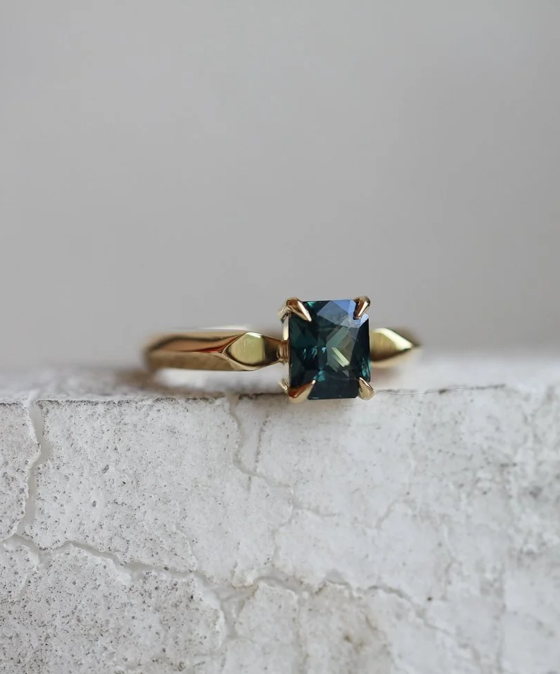Teal sapphire set in our Hester band.