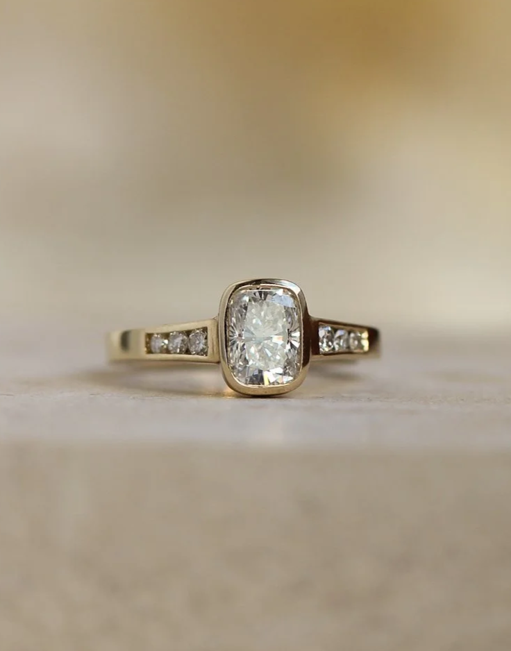 Lab grown diamond engagement ring. Bezel set centre stone, with channel set side stones. Made with customers own gold.