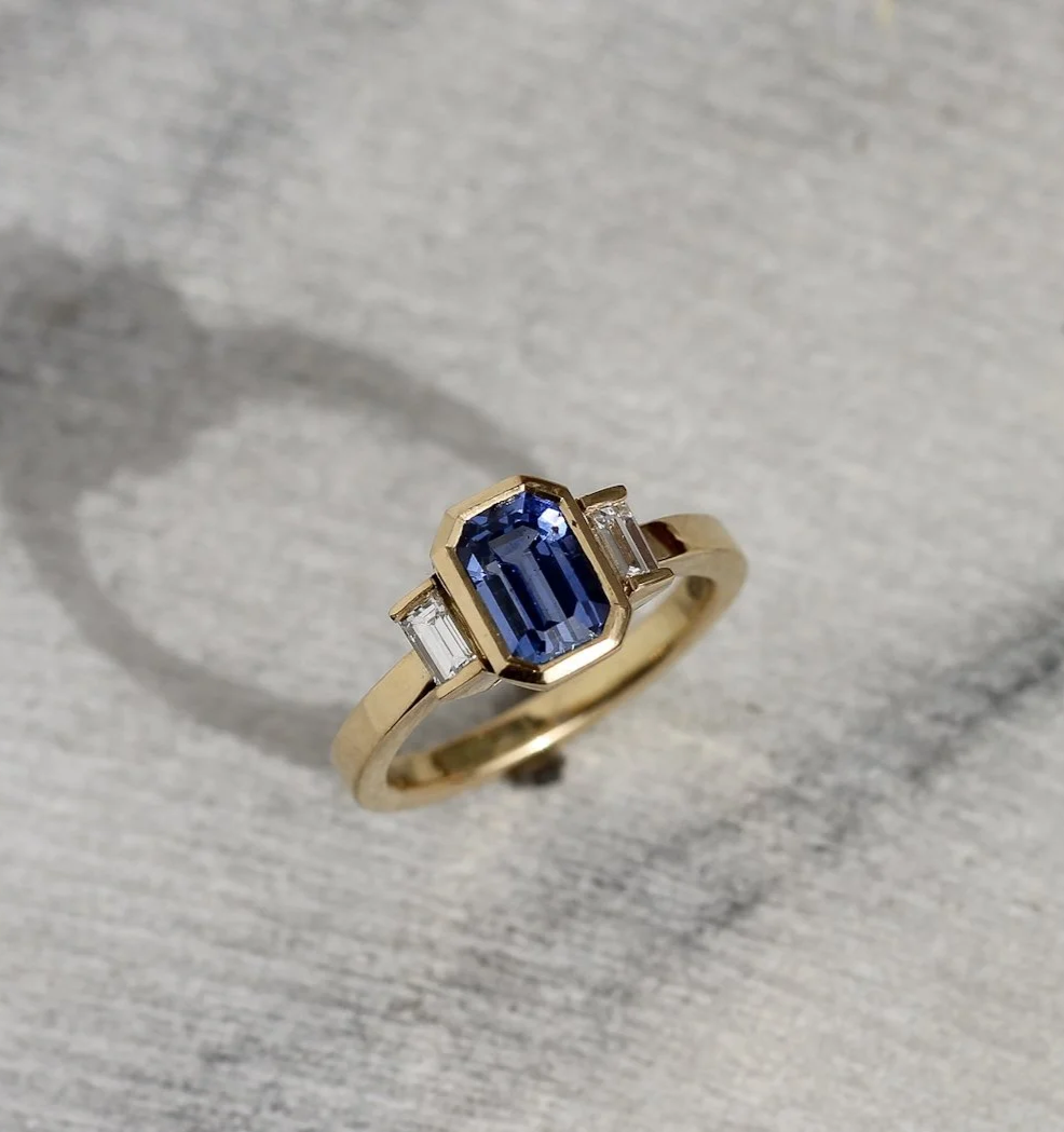 A 1.5ct emerald cut sapphire, with baguette cut diamonds 