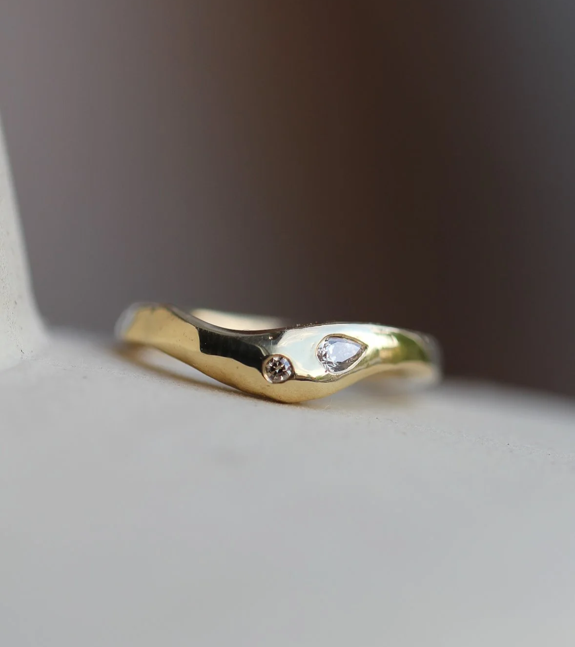 Champagne diamonds set in an organic wedding band. Made to fit around an engagement ring