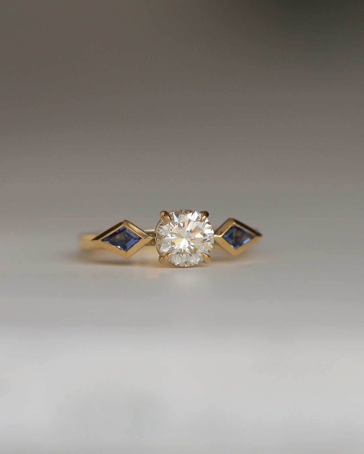 White diamond with kite shaped sapphire side stones.