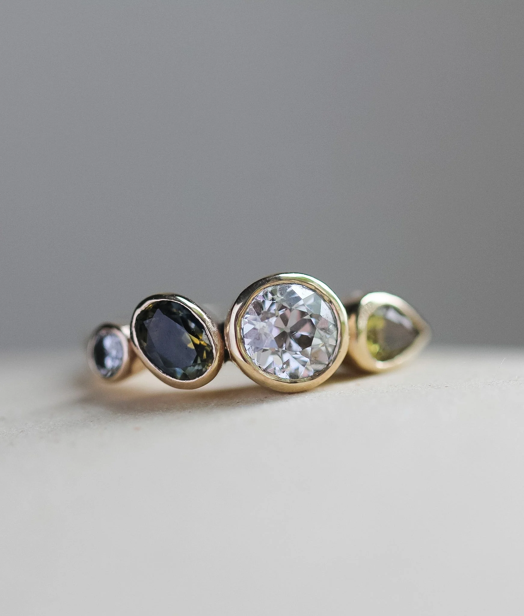 Heirloom diamond, bezel set alongside blue and yellow sapphires.