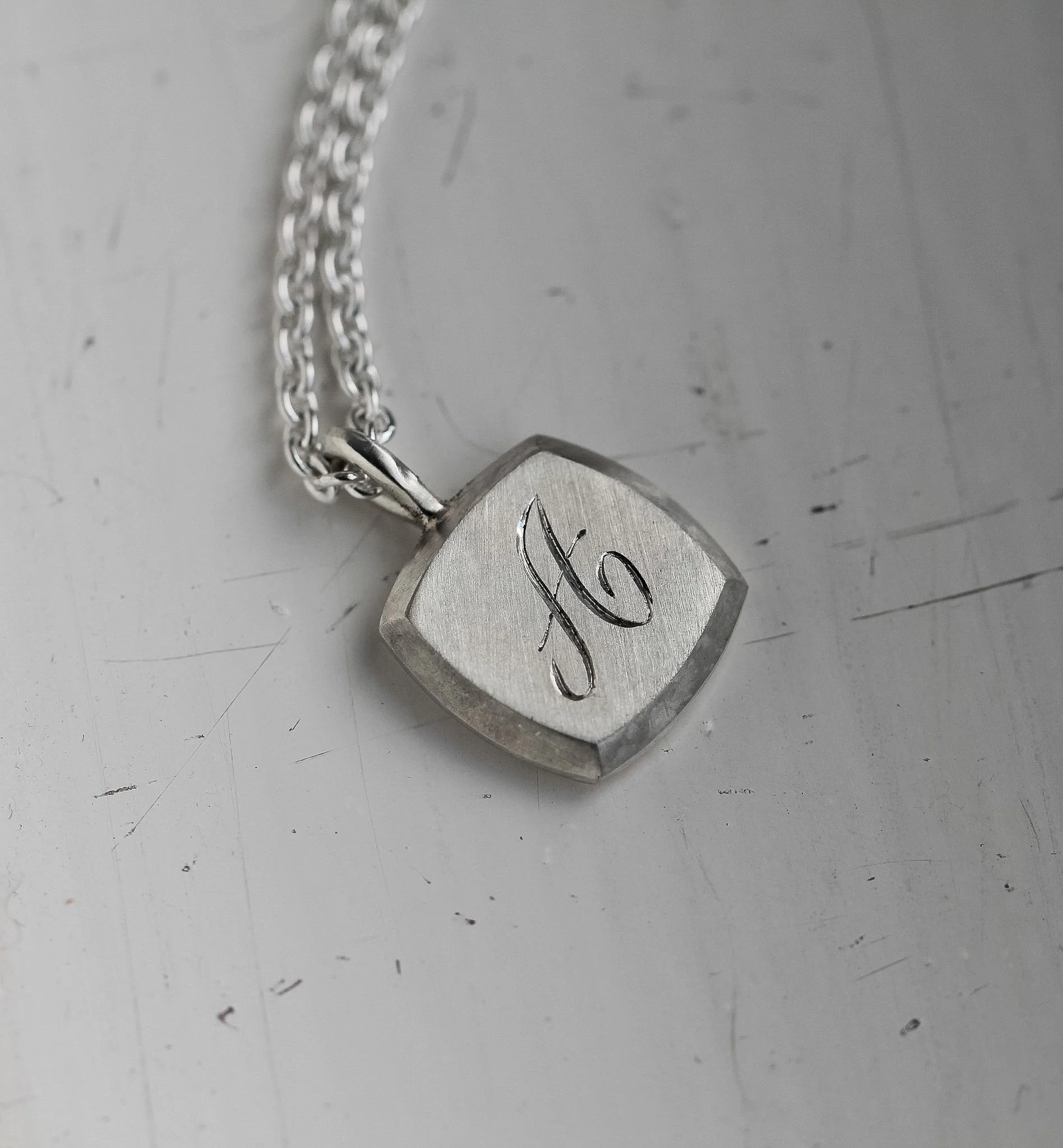 Engraved pendant with loved ones initial.