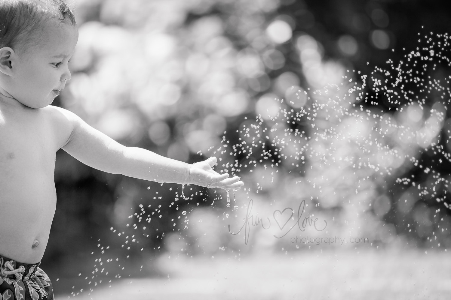 toddler-boy-playing-in-sprinkler-toronto-family-photography