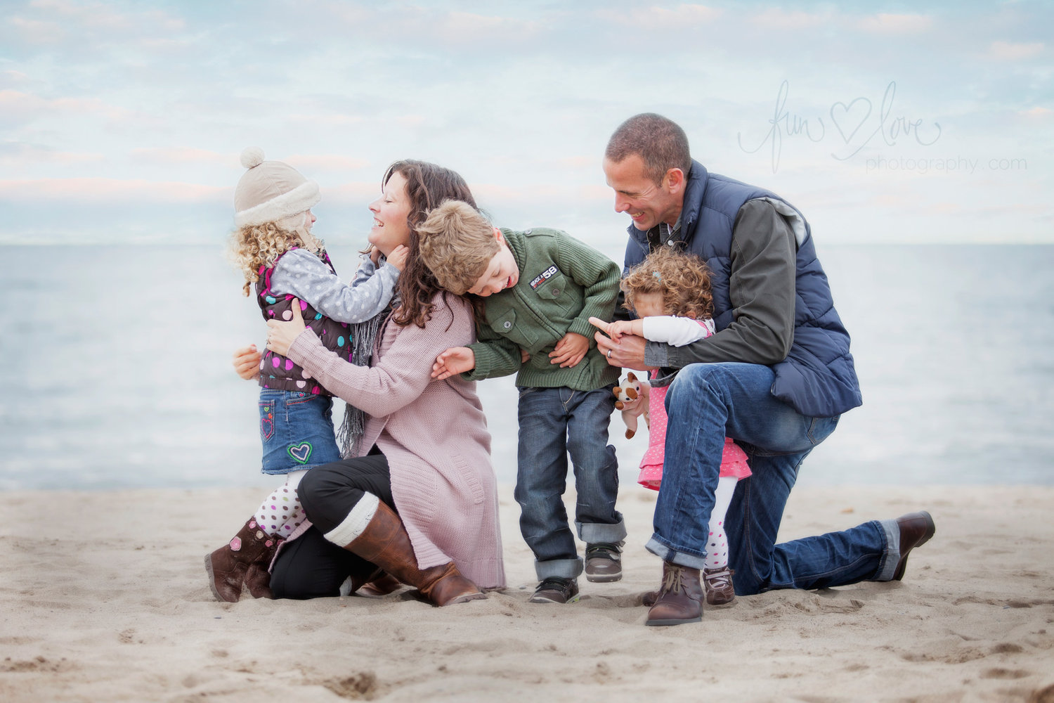 family dressed for autumn on the beach