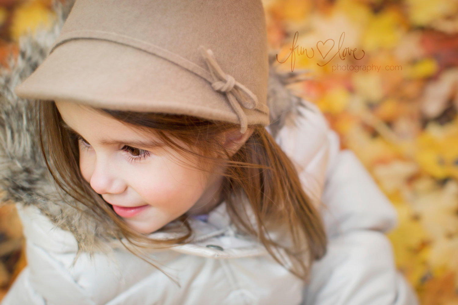 girl in felt hat and jacket in the fall leaves