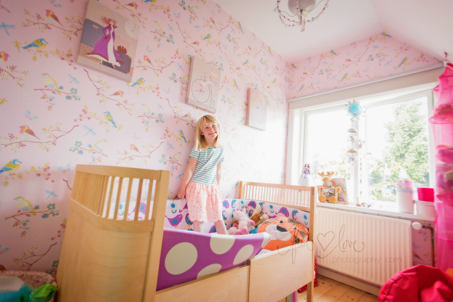 girl in pretty pink bedroom