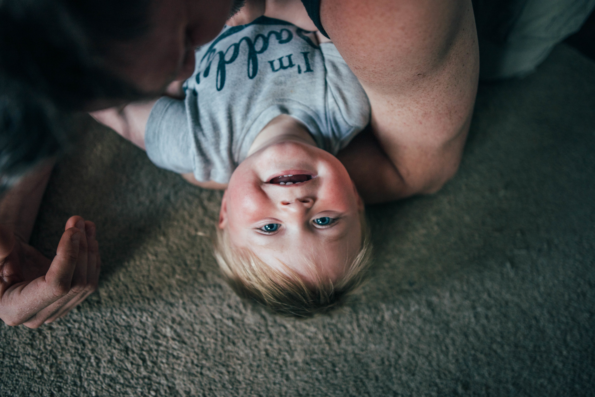 Upside Down baby boy smiling Essex UK Documentary Portrait and Lifestyle Photographer