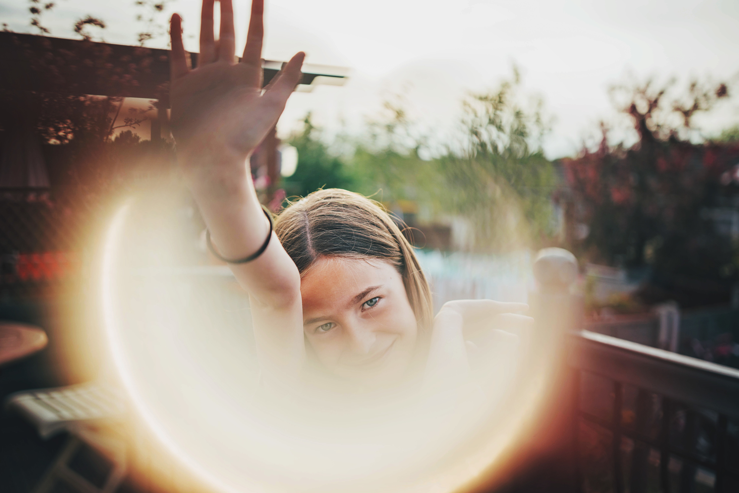 Young girl in garden sun flare Essex UK Documentary Portrait and Lifestyle Photographer