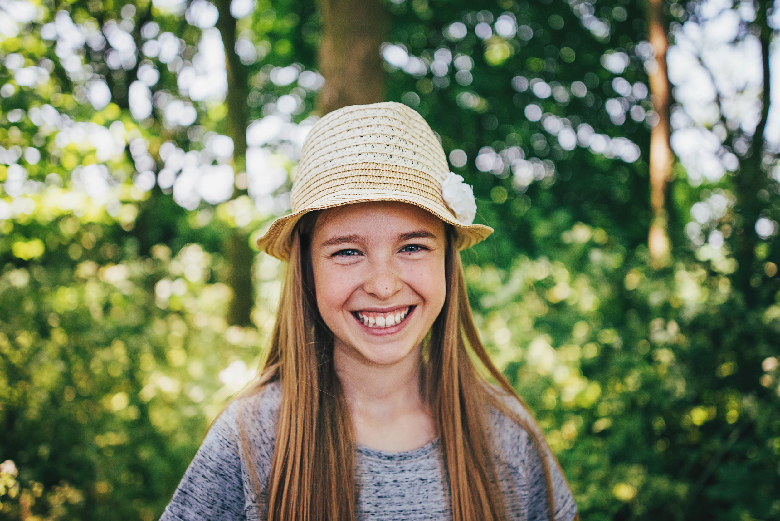 Tween girl in sunhat smiles Essex UK Documentary Portrait and Lifestyle Photographer