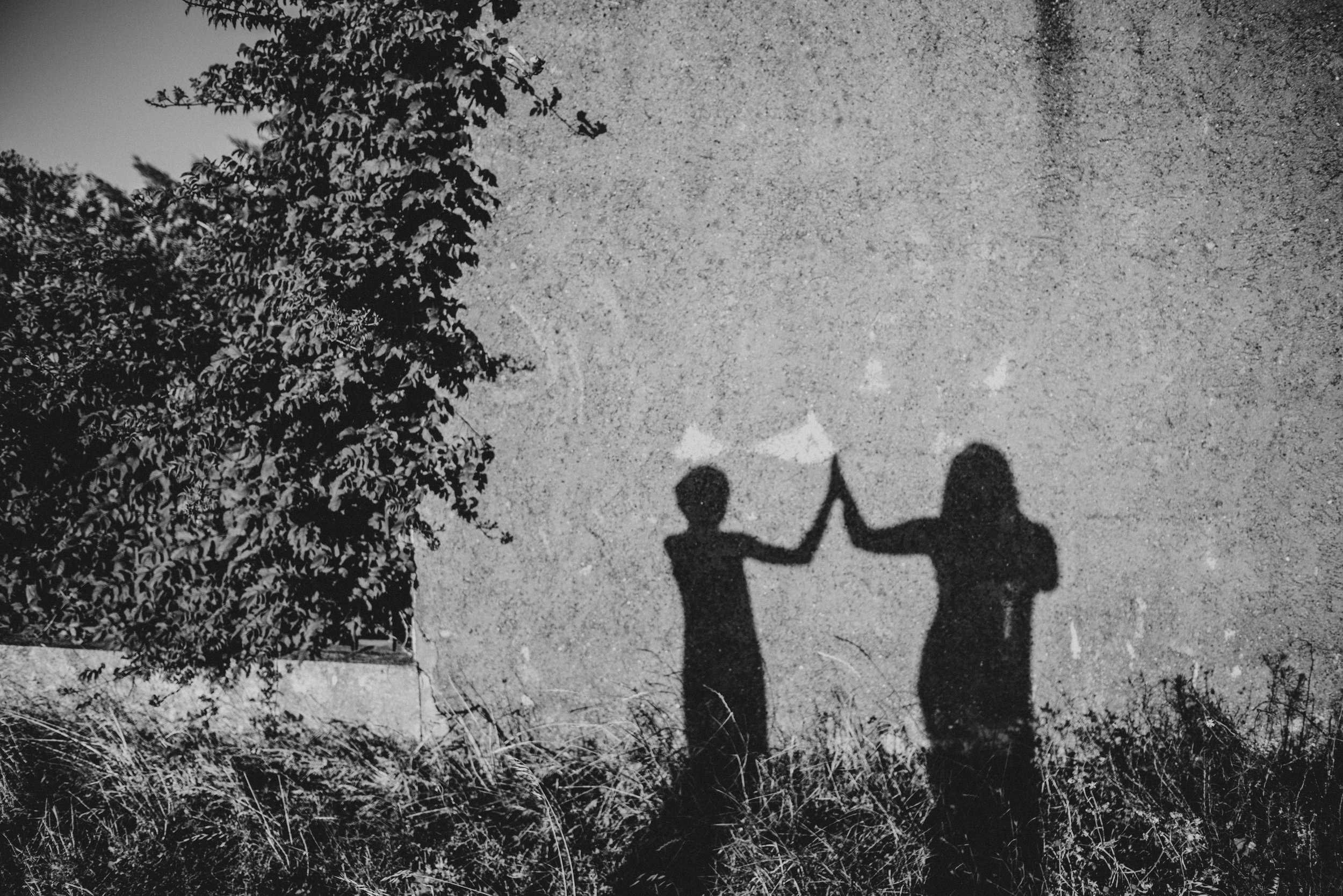 Shadows of two people high fiving Essex UK Documentary Portrait Photographer