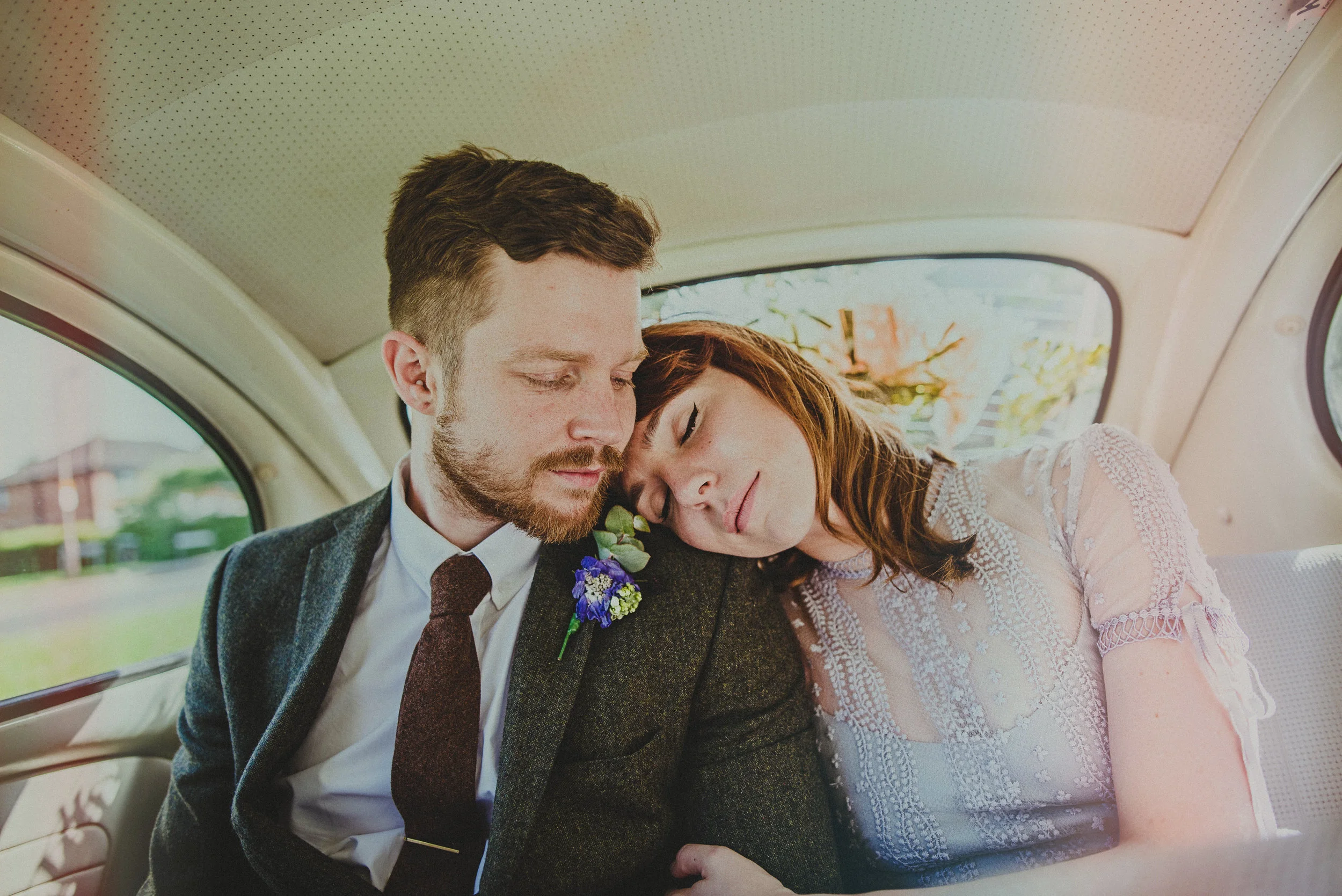 documentary wedding photographer essex bride groom in car vintage boho non-white flare village hall diy brentwood hutton