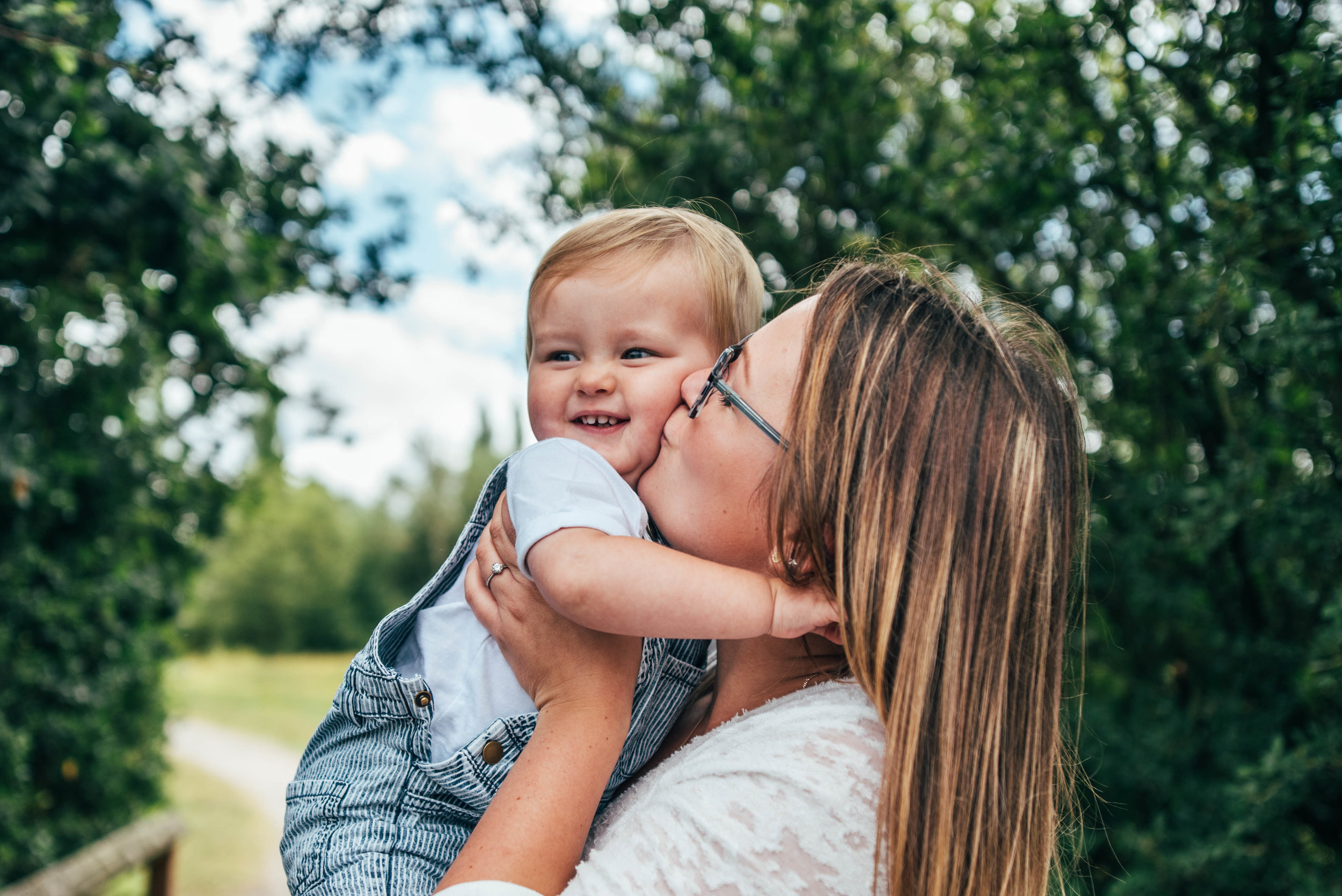 Mum kisses baby boy Essex UK Documentary Portrait Photographer