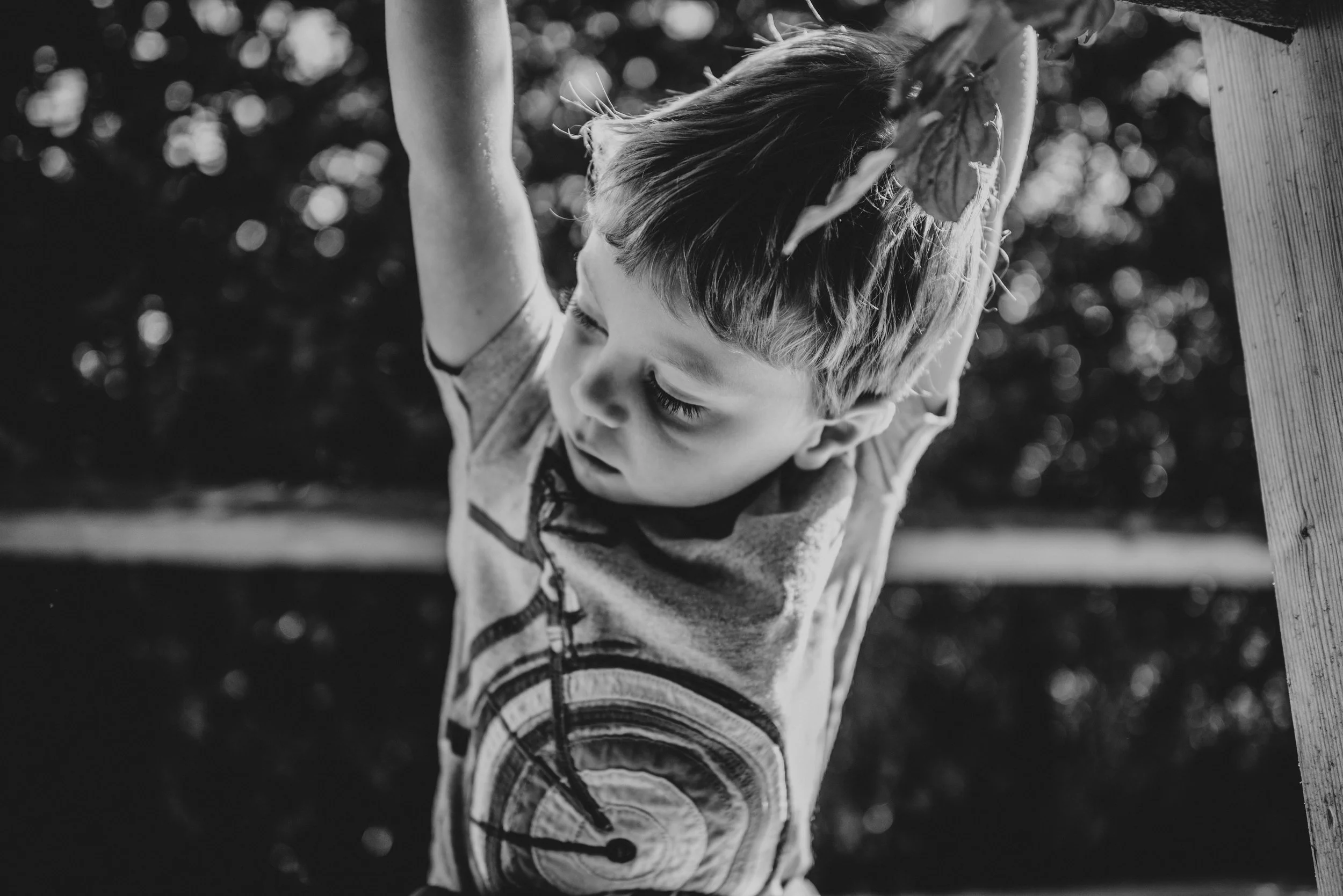 Little boy crouches on bridge Natural Essex UK Documentary Portrait Photographer