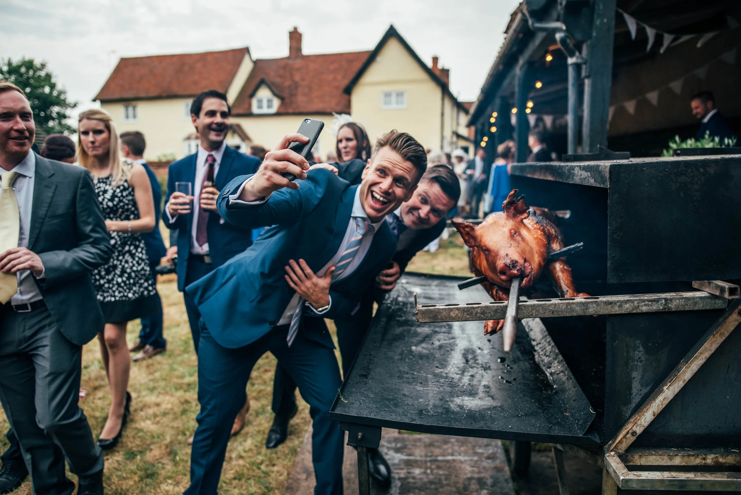 Essex UK Documentary Wedding Photographer Guests take selfie with Hog Roast Barn Farm Wedding