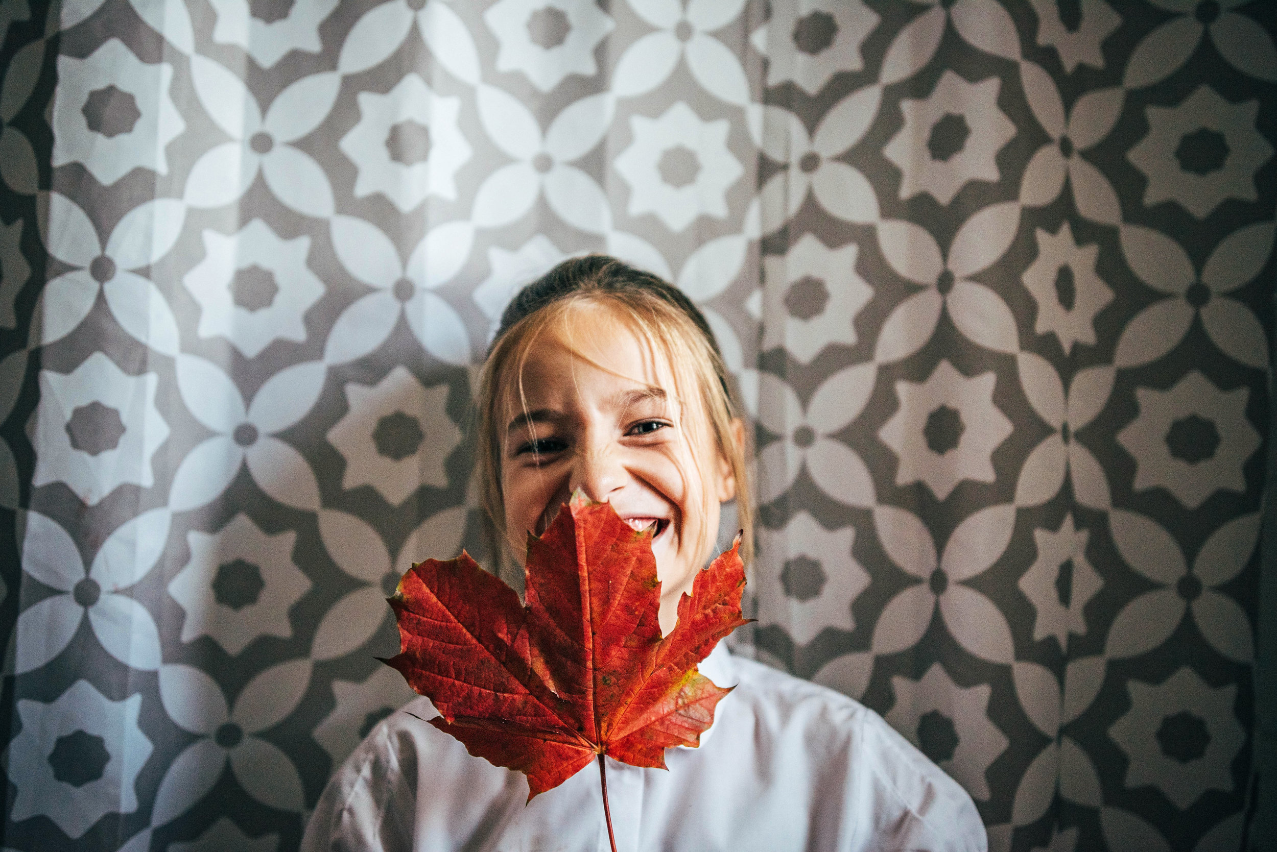 Little girl with Autumn Leaf Essex UK Documentary Lifestyle Portrait Photographer