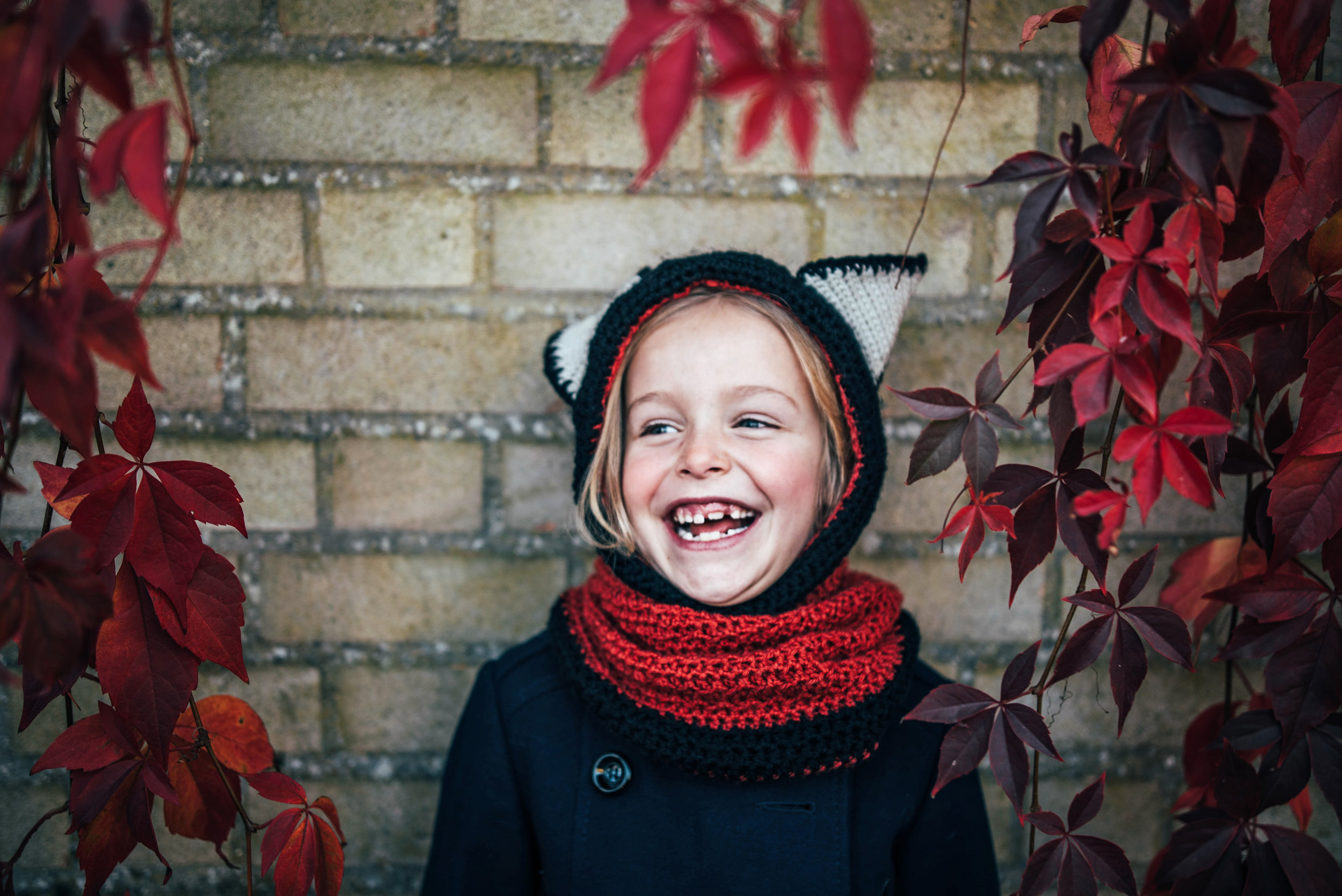 Little girl in Fox hat Autumn Leaves Essex UK Documentary Portrait Photographer