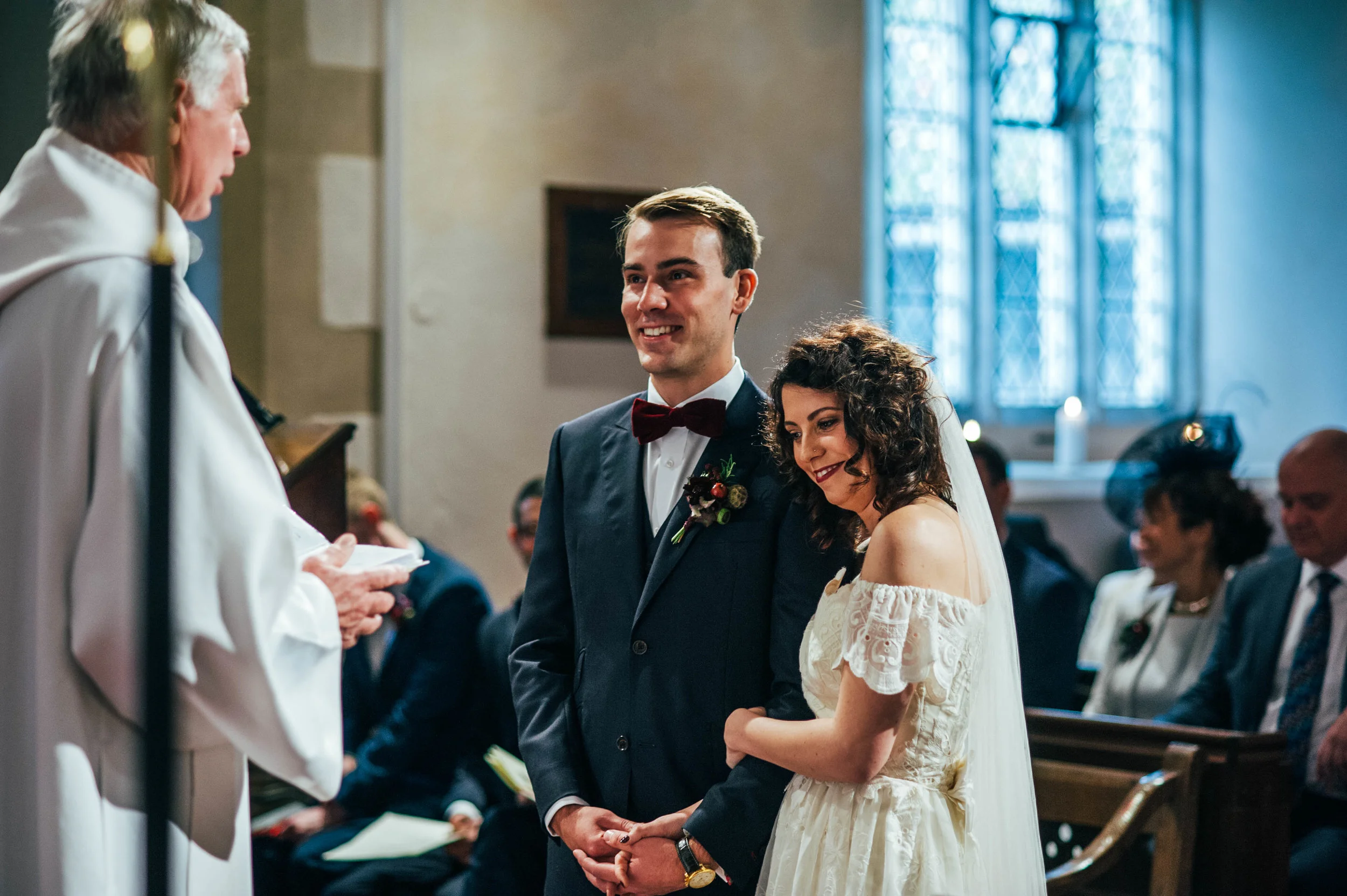 Bride leans Grooms shoulder during church ceremony Essex Documentary Wedding Photographer