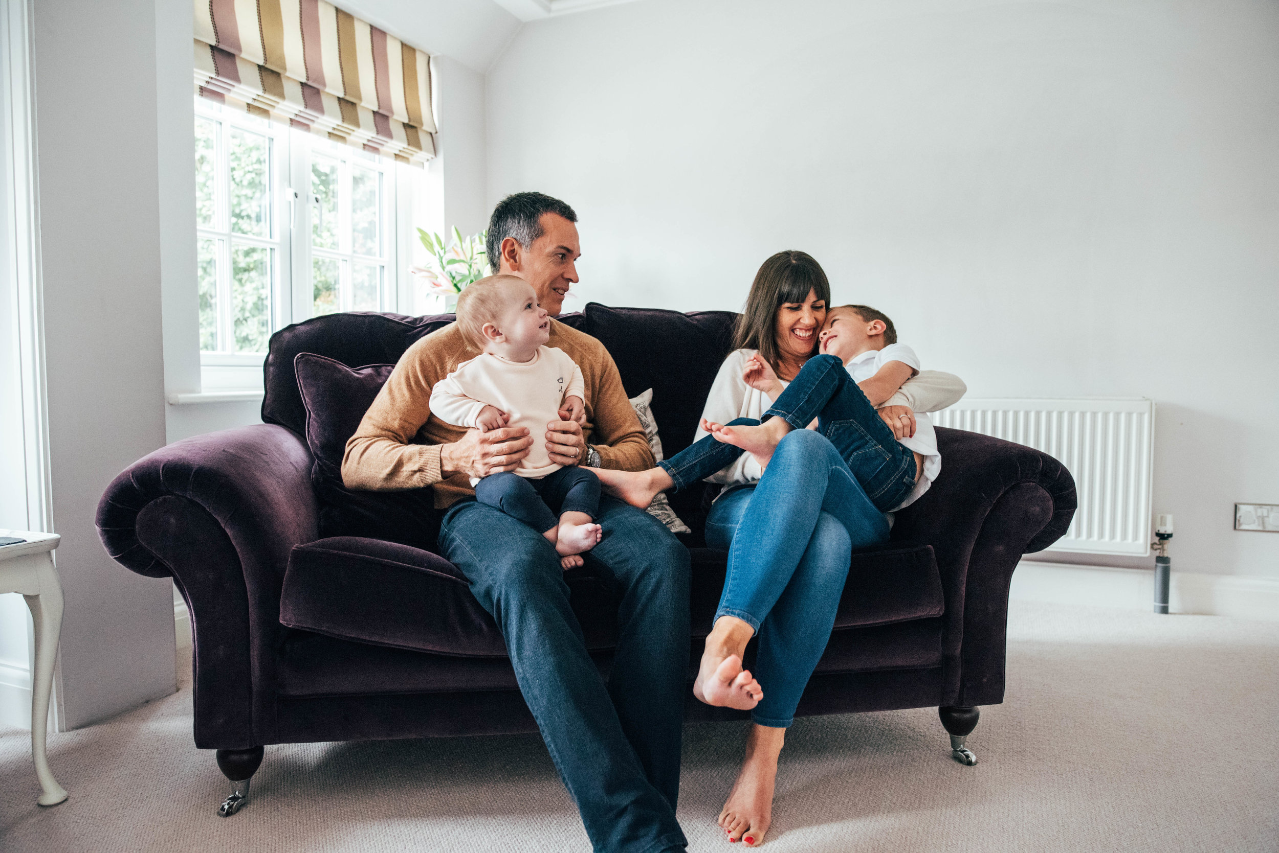 Family Lifestyle Shoot At home Family laugh on sofa Essex UK Documentary Portrait Photographer