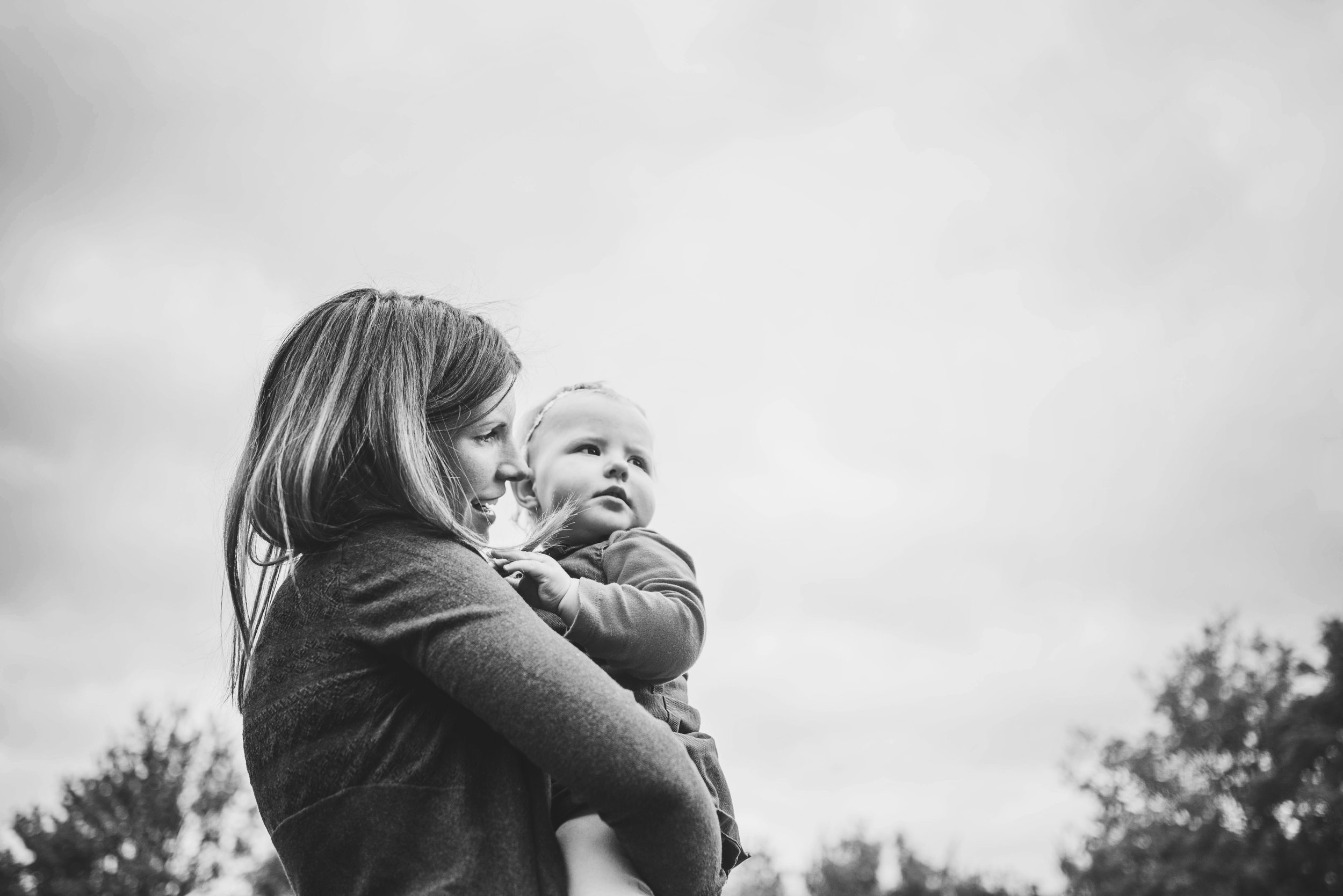 Mum holds baby girl At Home Lifestyle Shoot Essex UK Documentary Portrait Photographer