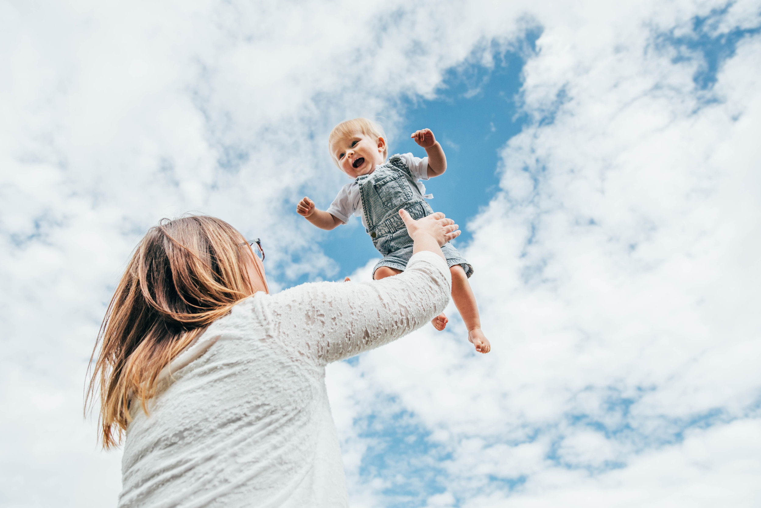 Mum throws baby in air Lifestyle Shoot Essex UK Documentary Portrait Photographer