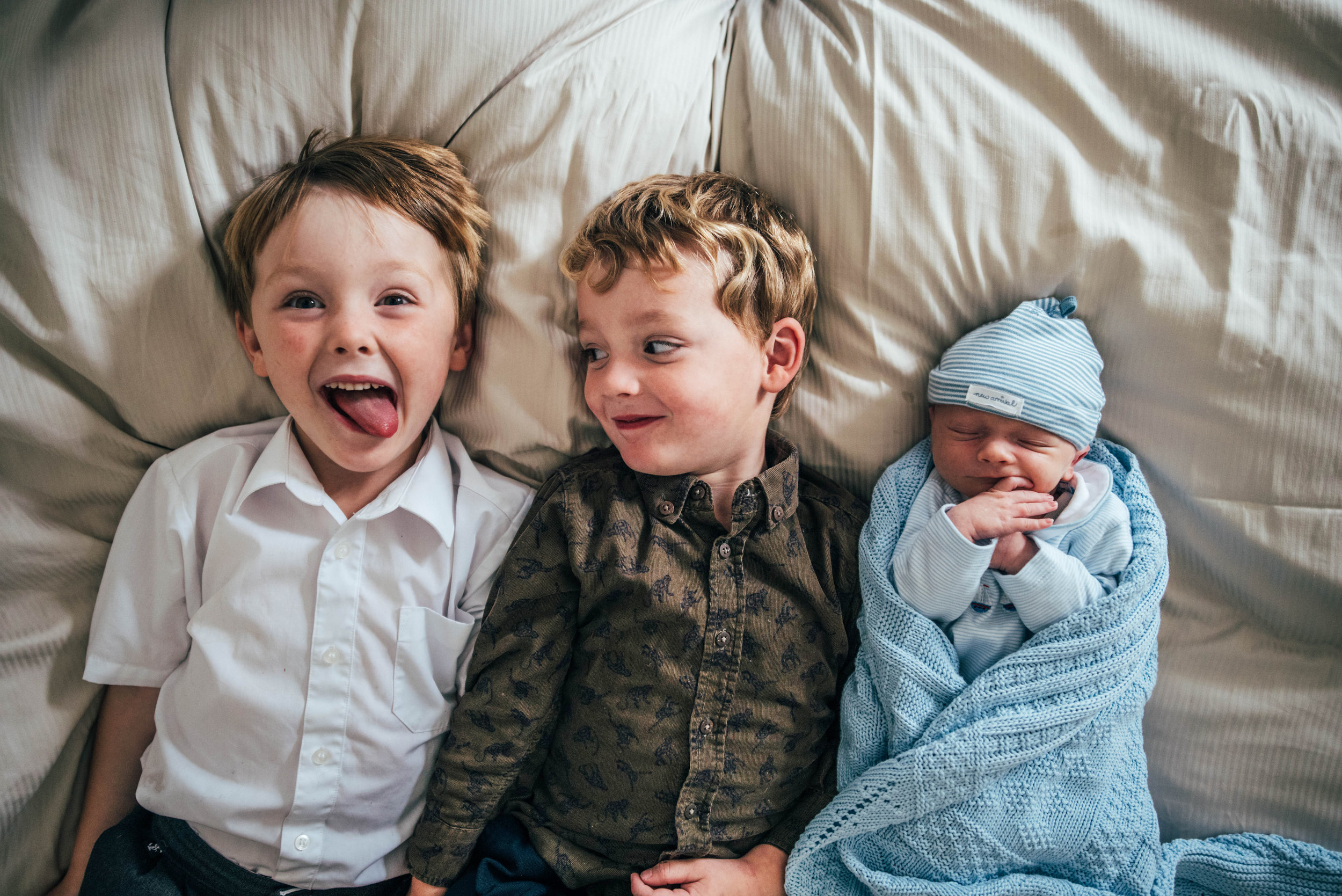 Three Brothers on Bed Newborn baby At Home Shoot Lifestyle Essex UK Documentary Portrait Photographer