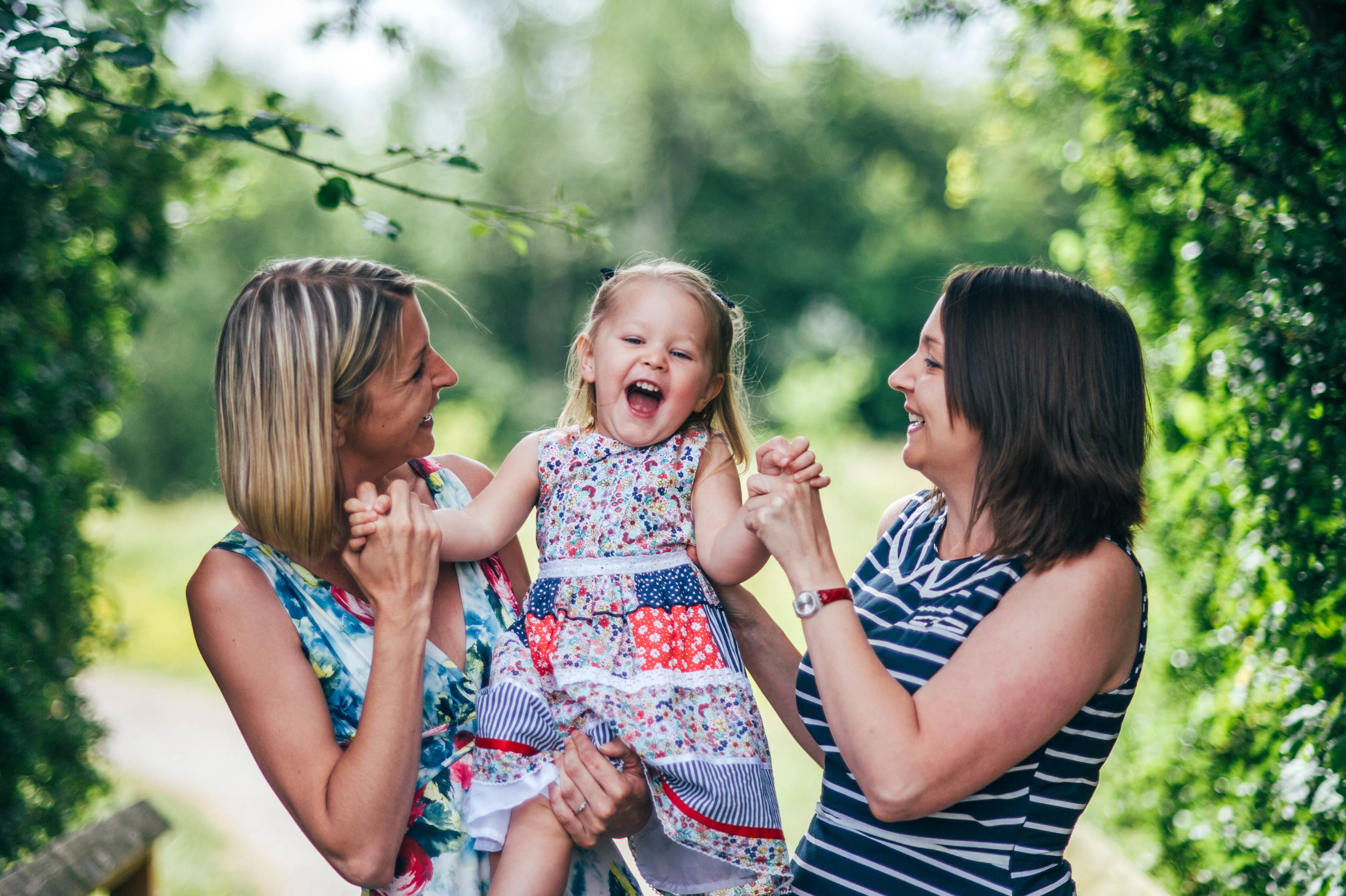 Little girl laughs with Mum and Aunt Lifestyle Shoot Essex UK Documentary Portrait Photographer