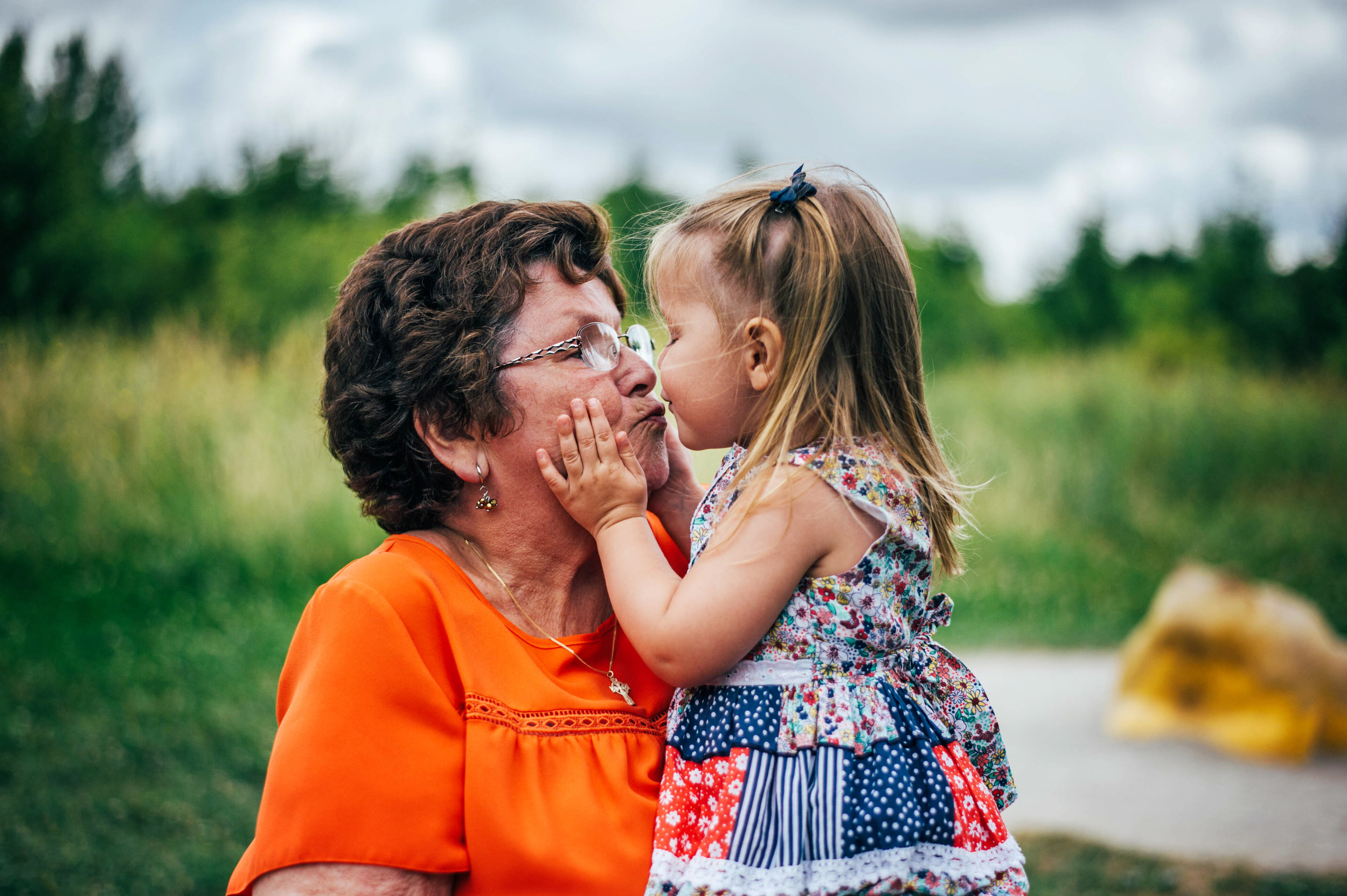 Little girl kisses Grandma Lifestyle Shoot Essex UK Documentary Portrait Photographer