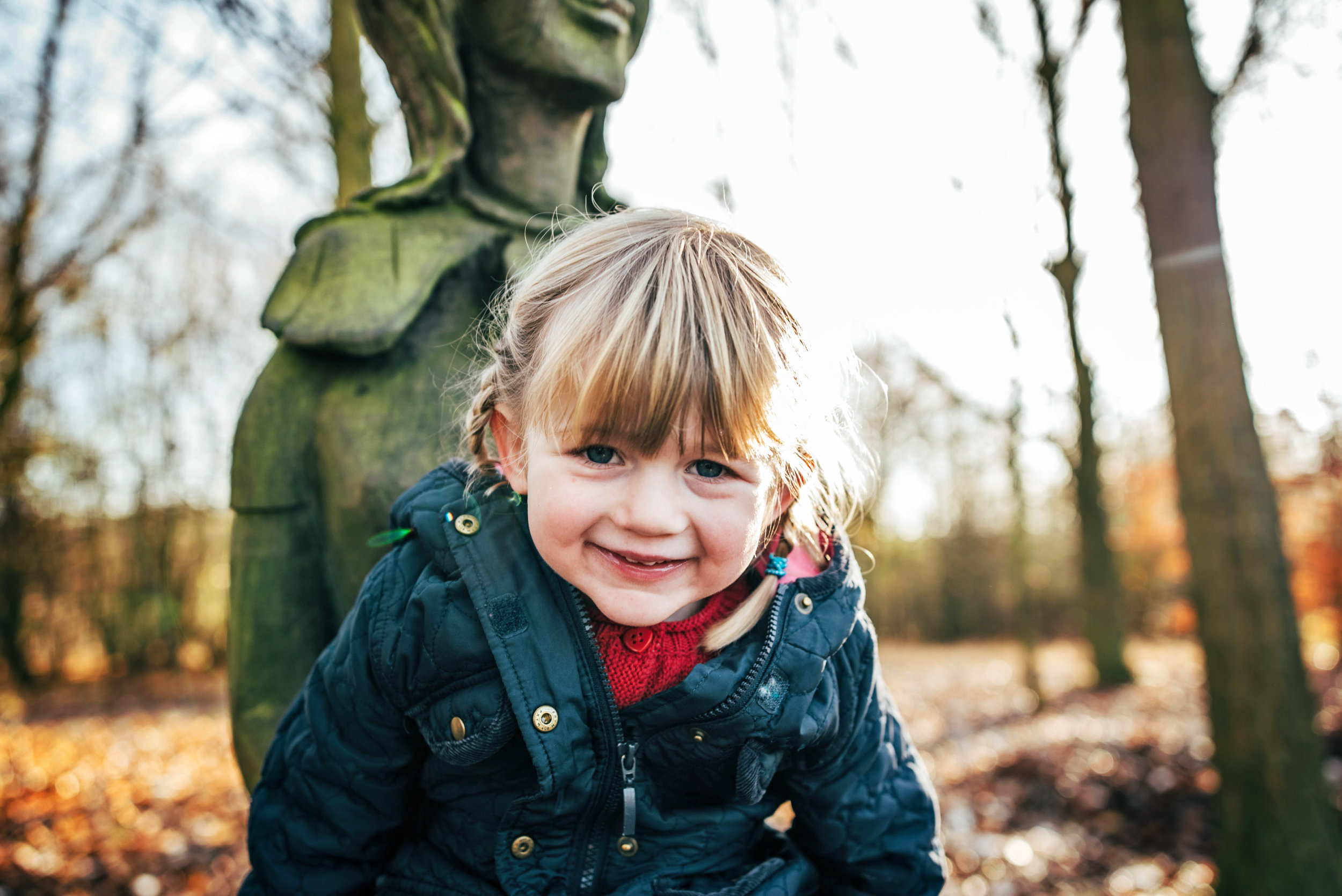 Little girl looks into camera with Autumn light Lifestyle Shoot Essex UK Documentary Portrait Photographer