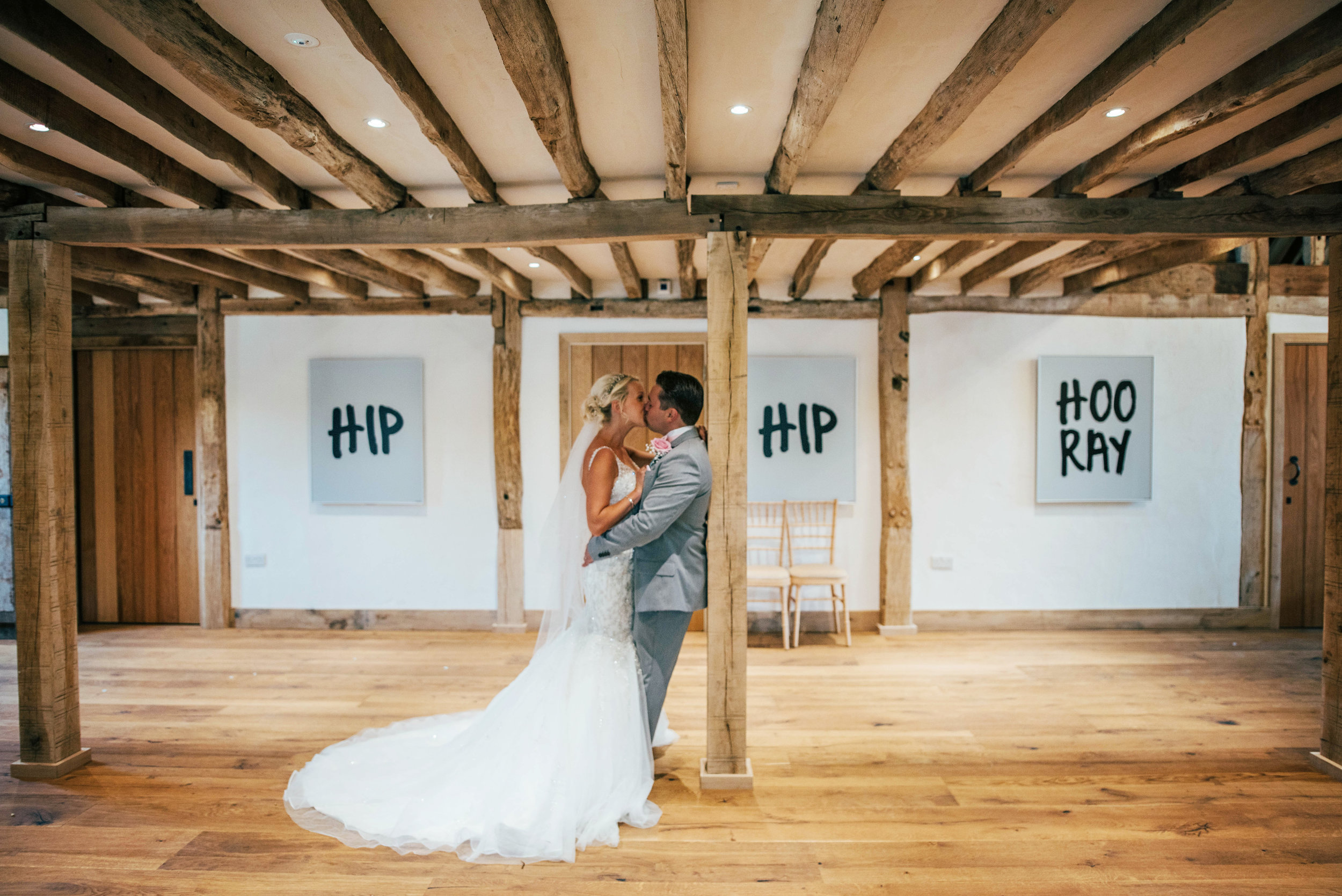 Bride & Groom kiss in Barn Blake Hall Ongar Wedding Essex UK Documentary Photographer
