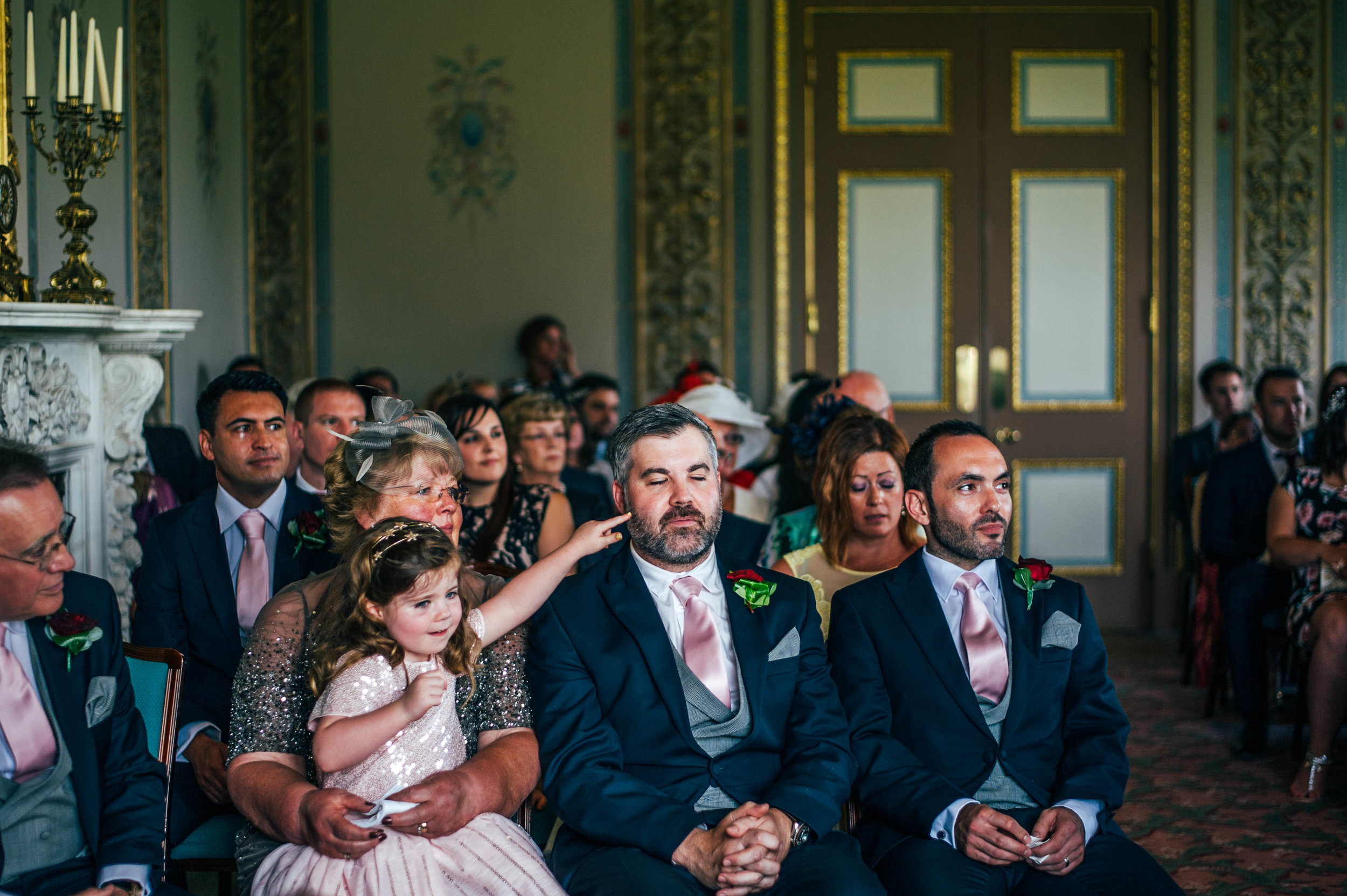 Little girl pokes Dads face Hylands House Chelmsford Wedding Essex UK Documentary Photographer