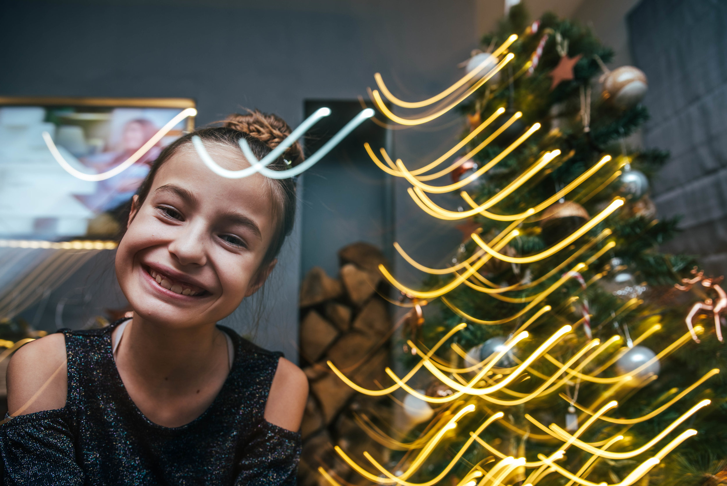 Girl with light trails by Christmas Tree Essex UK Documentary Photographer