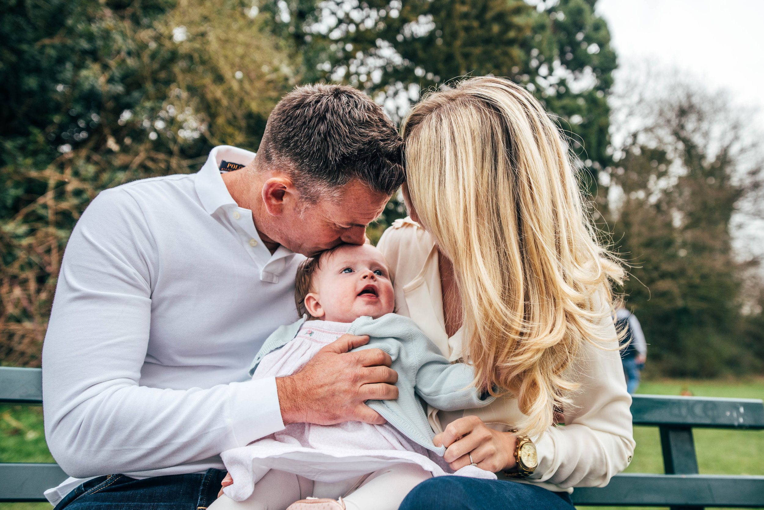 Young Parents with baby girl in Essex park for Spring Portraits