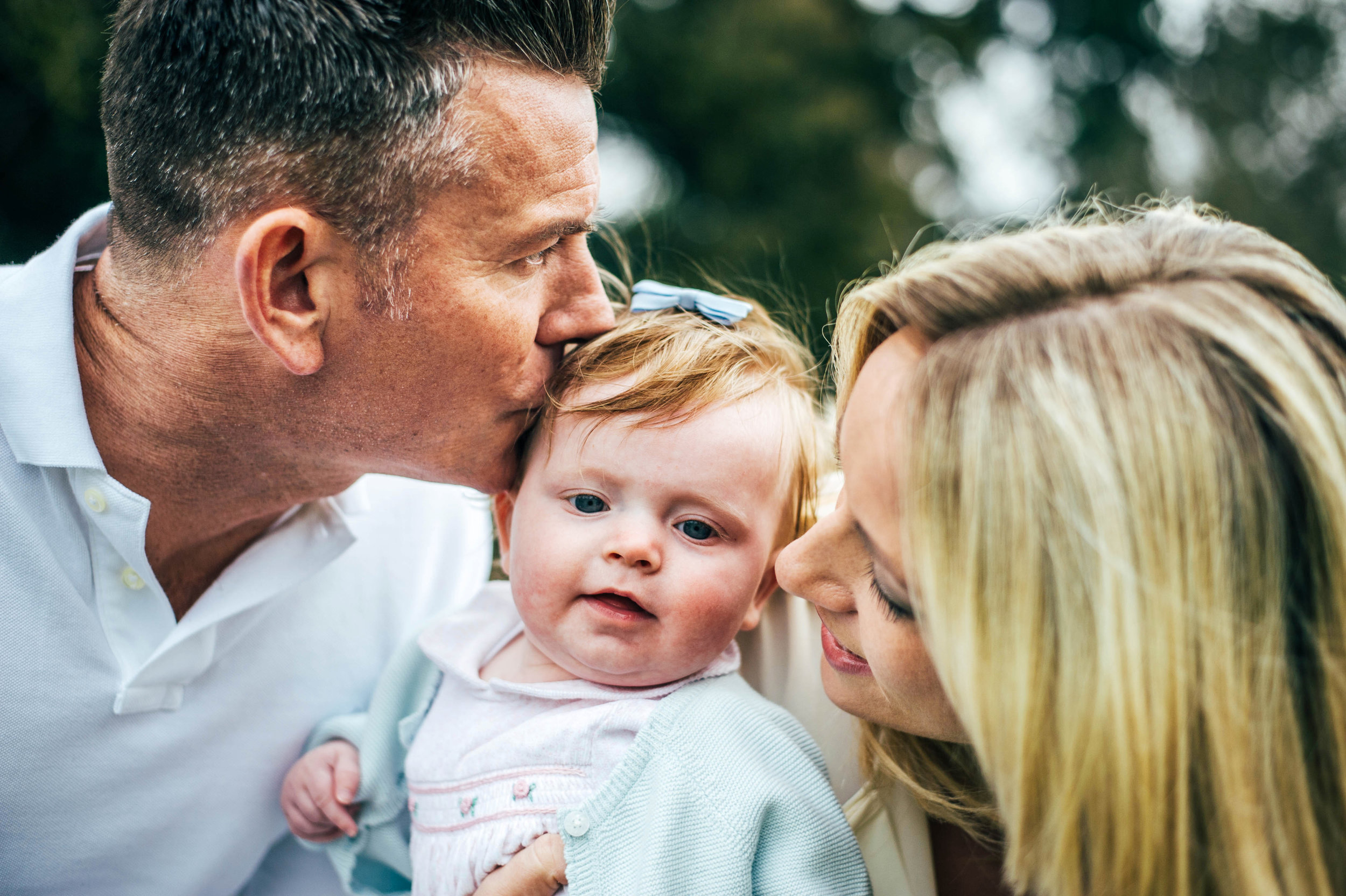 Young Parents with baby girl in Essex park for Spring Portraits