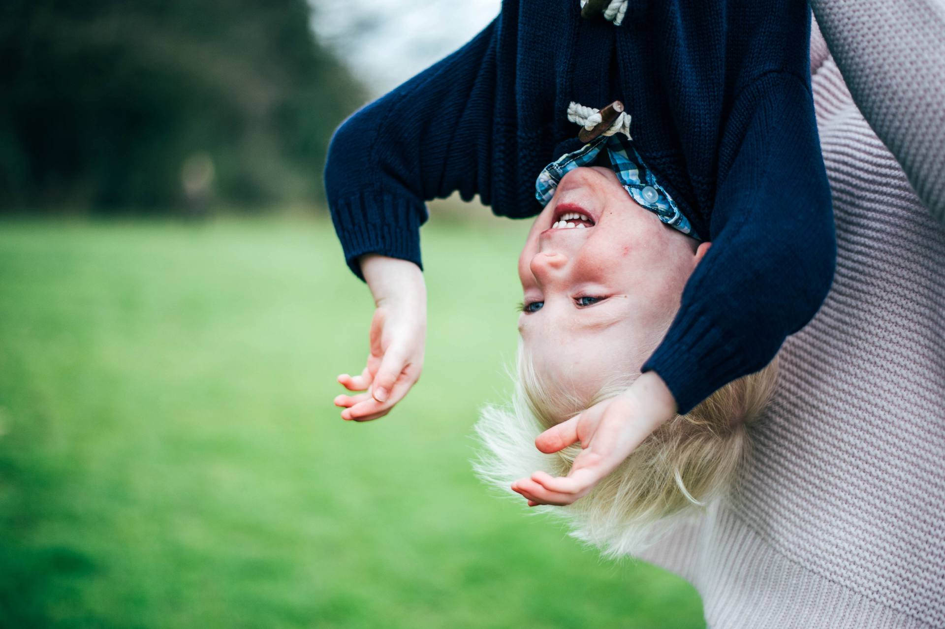 Upside down toddler boy documentary portrait shoot in Essex Park