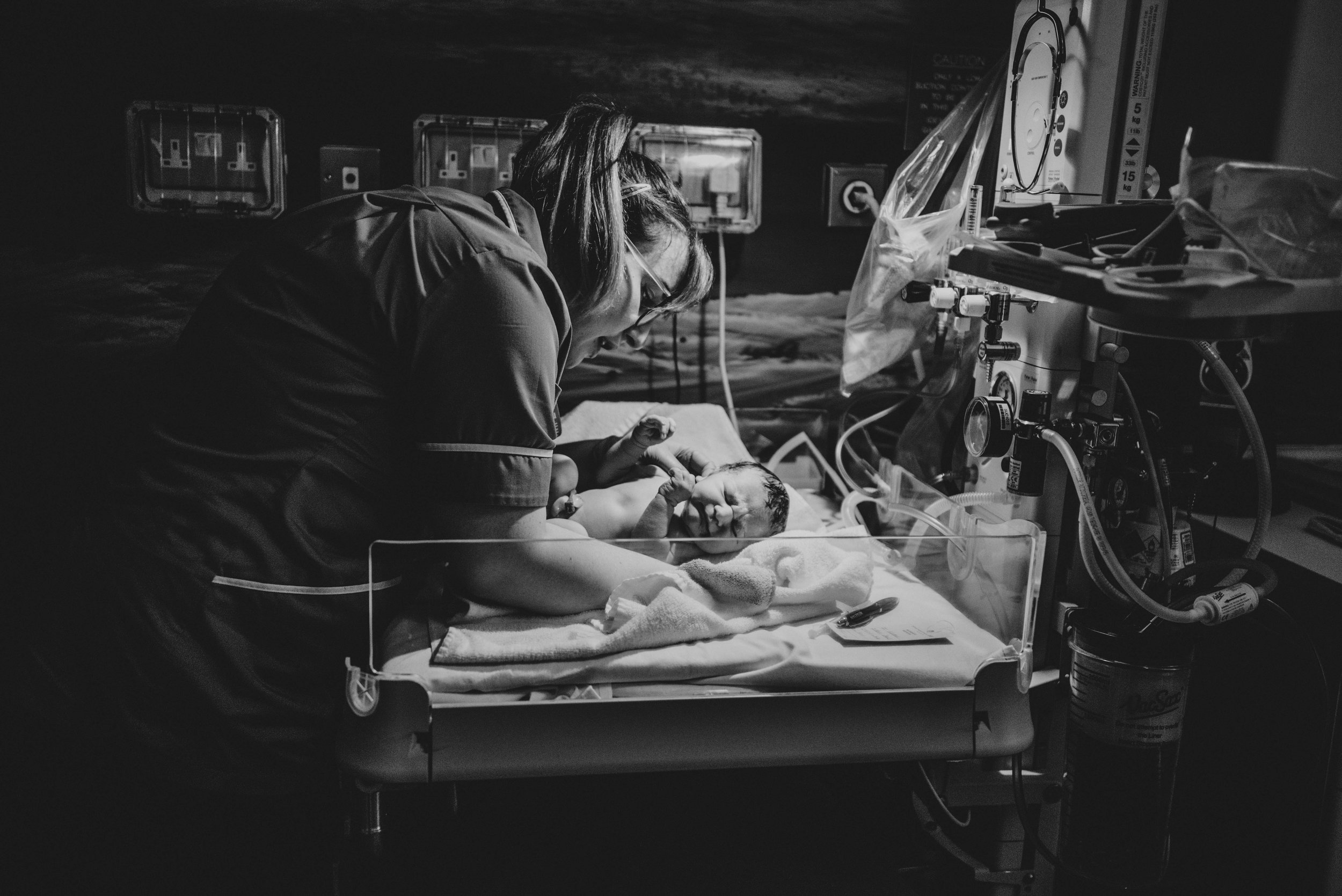 Newborn baby in delivery room has checks Essex UK Documentary photographer