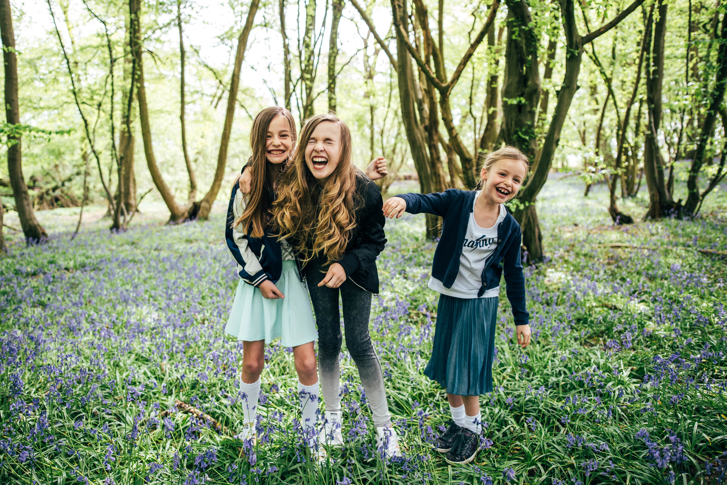 Three girls in Bluebell woodland Essex UK Documentary Lifestyle Portrait Photographer 