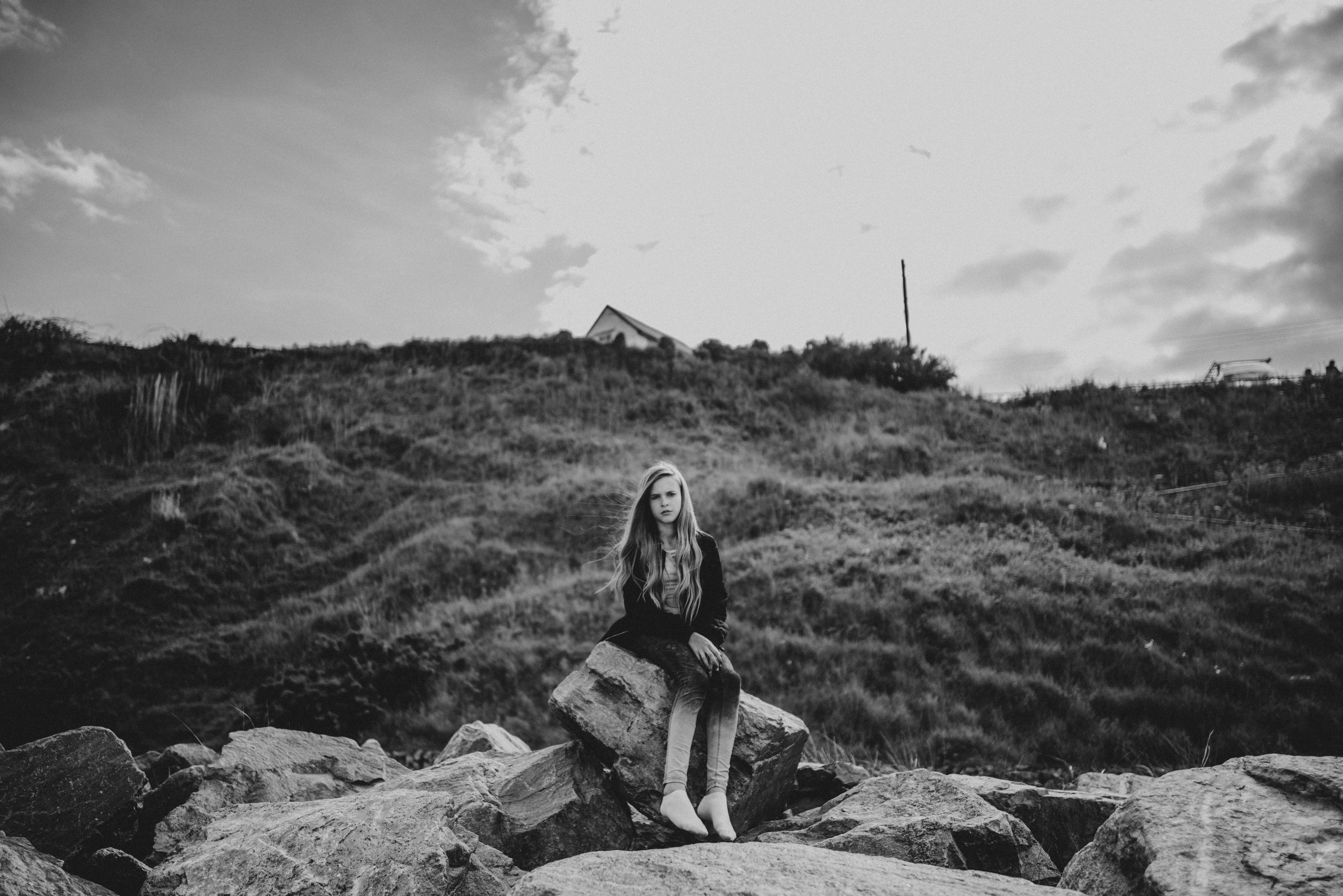 Teen girl sits on beach Essex UK Documentary Lifestyle Portrait Photographer