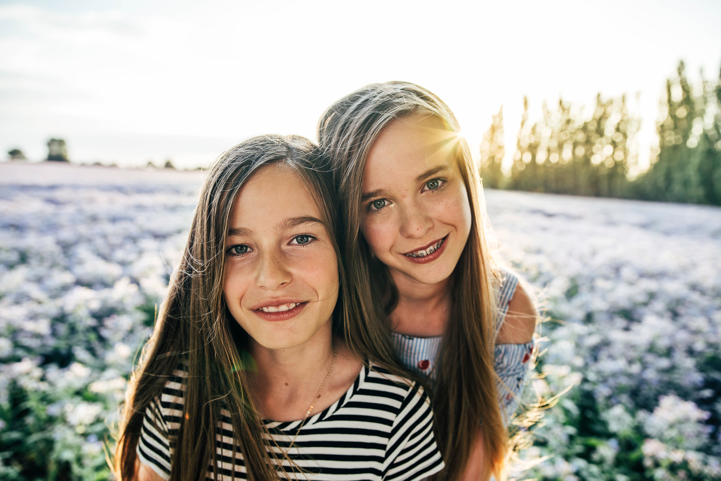 Two sisters in purple field at sunset Essex UK Documentary Portrait Photographer