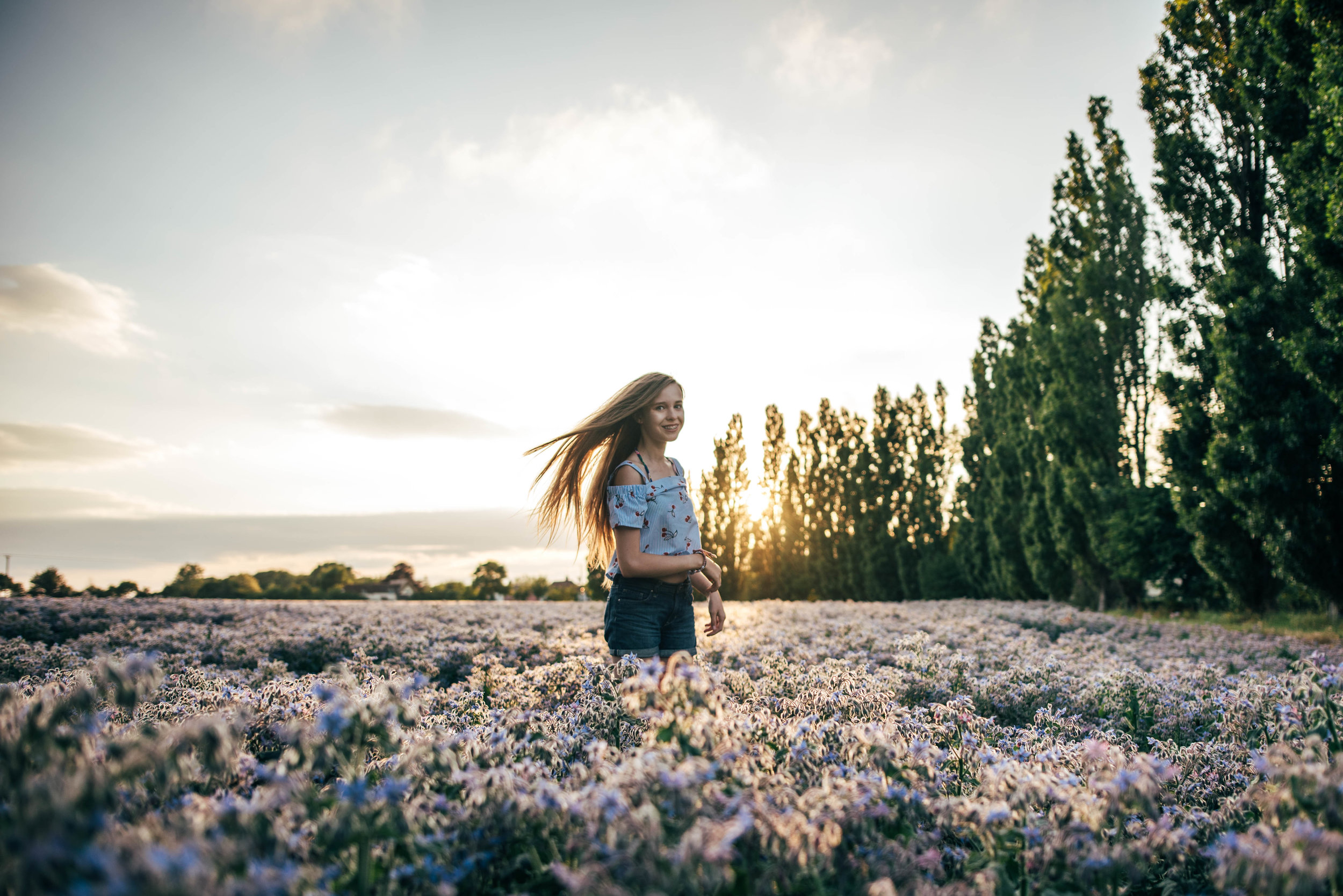 teen girl in purple field at sunset Essex UK Documentary Portrait Photographer