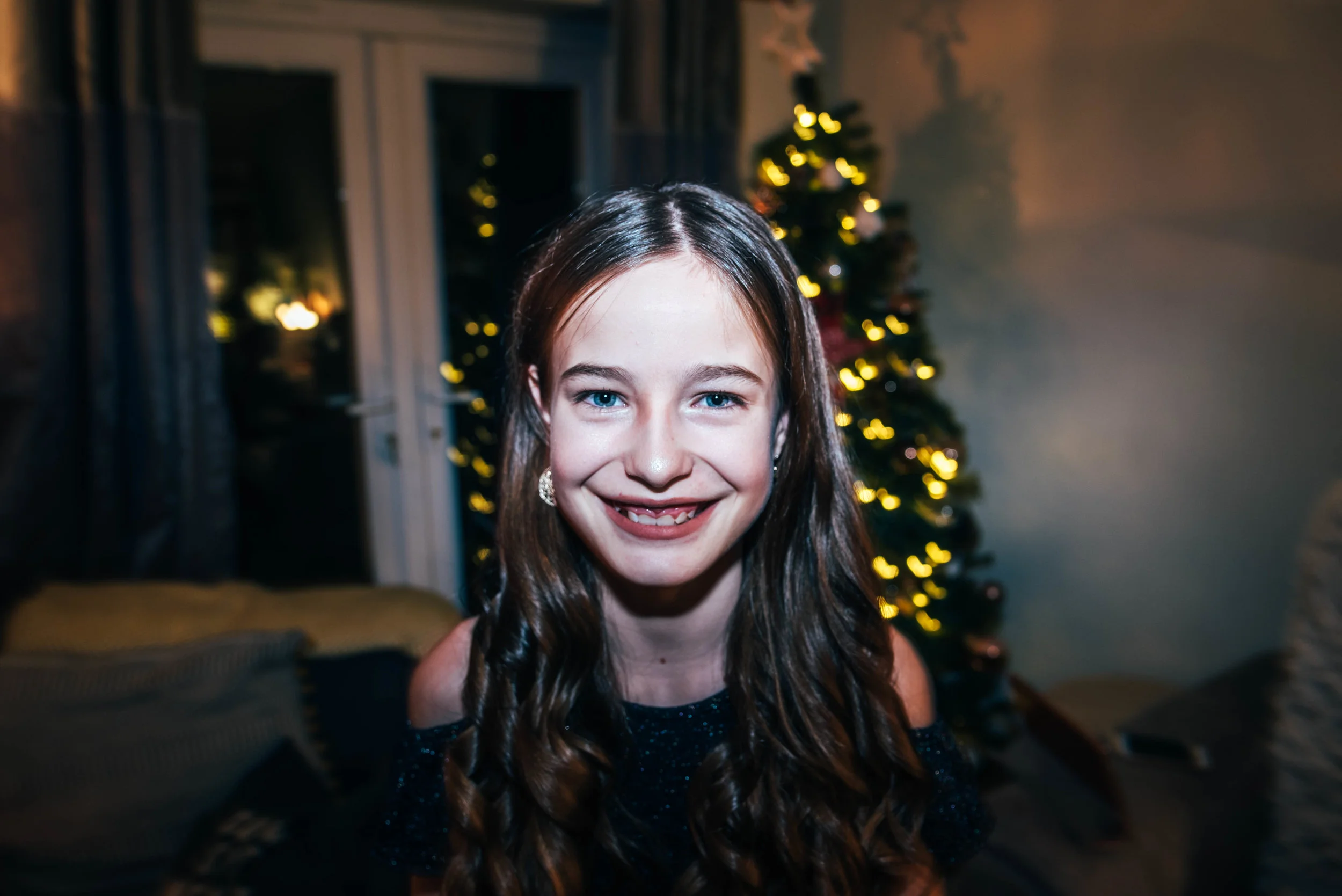 Tween girl infront of Christmas Tree Essex UK Wedding Documentary Photographerw
