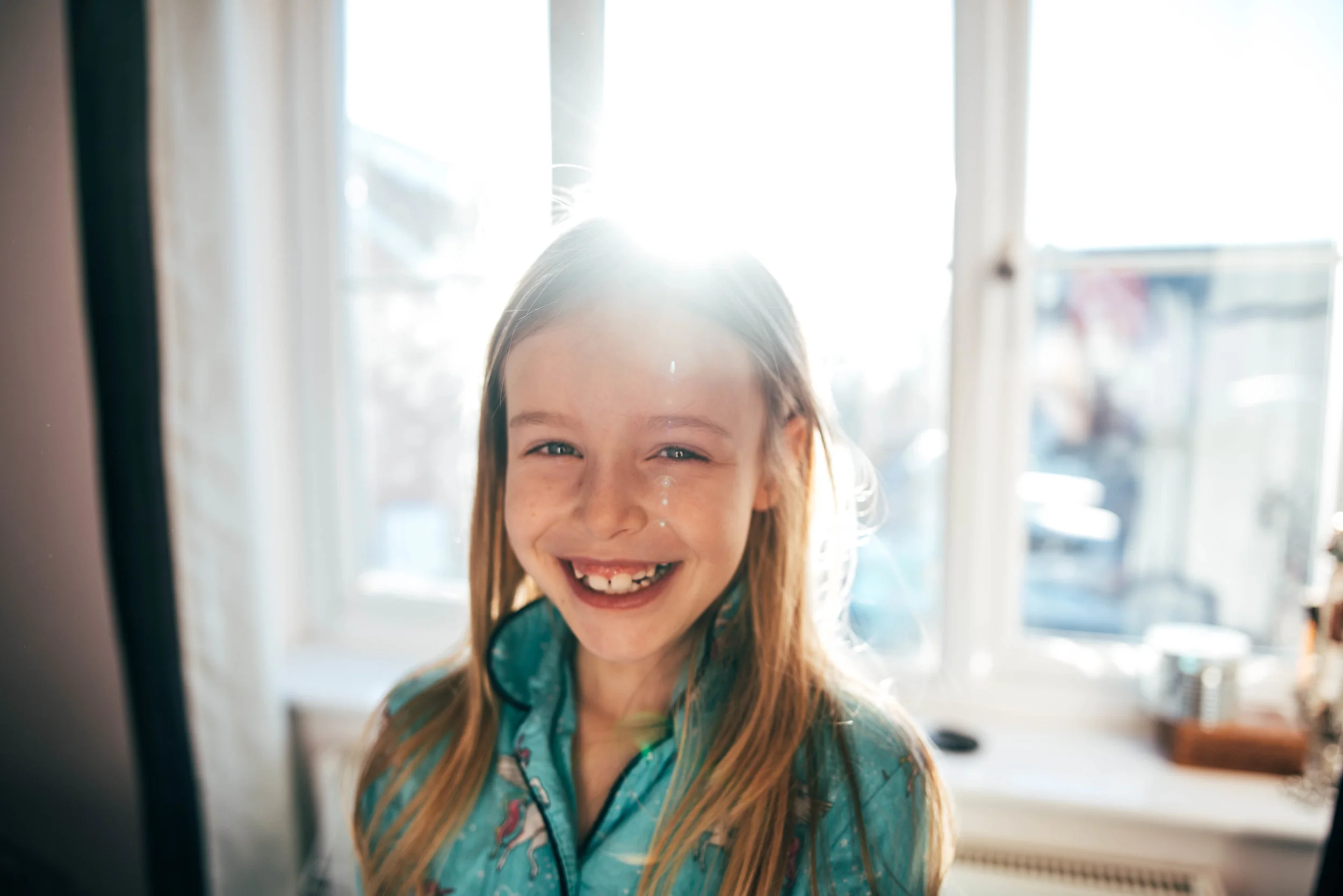 Little girl in sunny room Essex UK Wedding Documentary Photographer