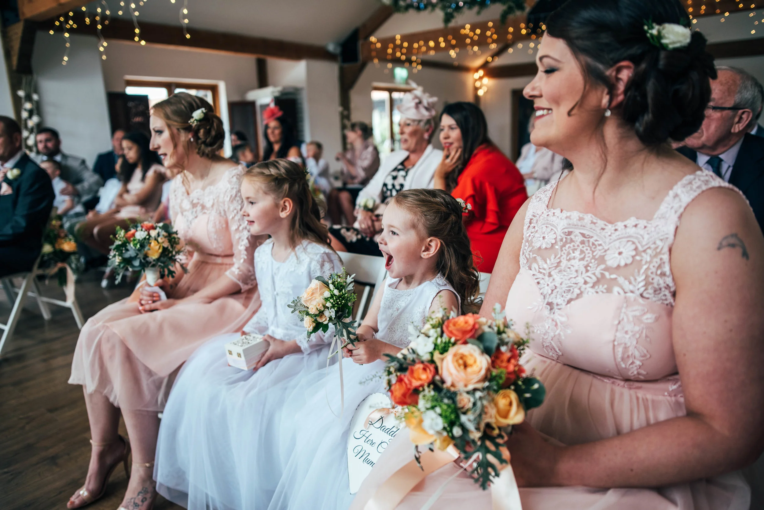 Flower girl excited to see her parents get married Maidens Barn wedding Essex Documentary Wedding Photographer