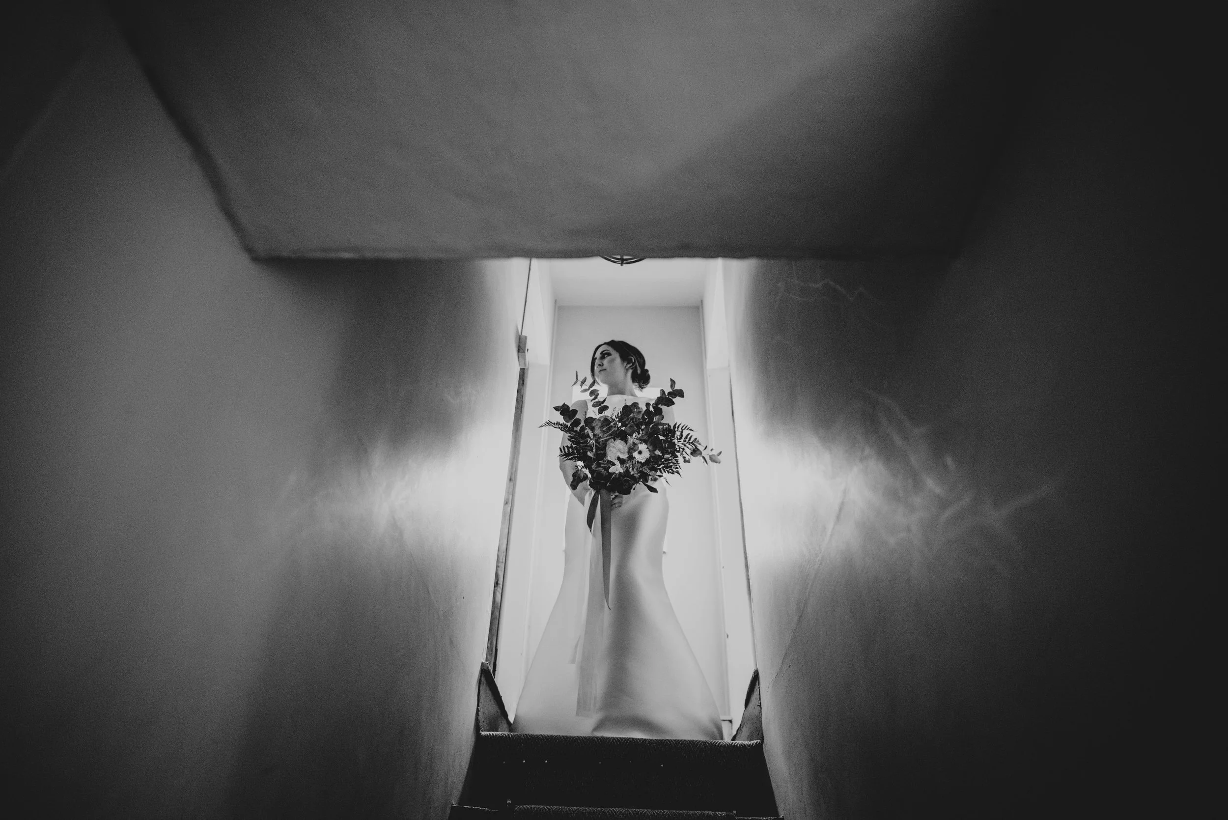 Bride at top of staircase Essex Documentary Wedding Photographer