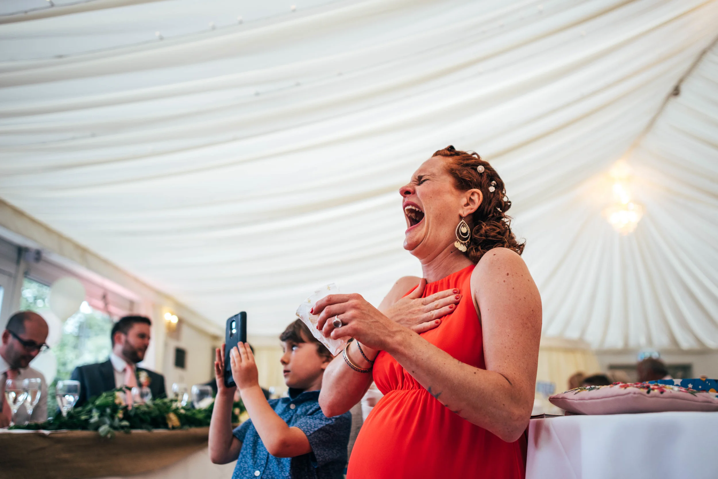 Guest laughing at speeches Fennes Essex Documentary Wedding Photographer